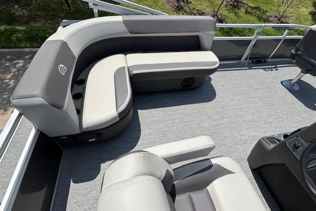 2026 Sun Tracker Bass Buggy 16 XL Select pontoon boat interior with gray seating and carpet.