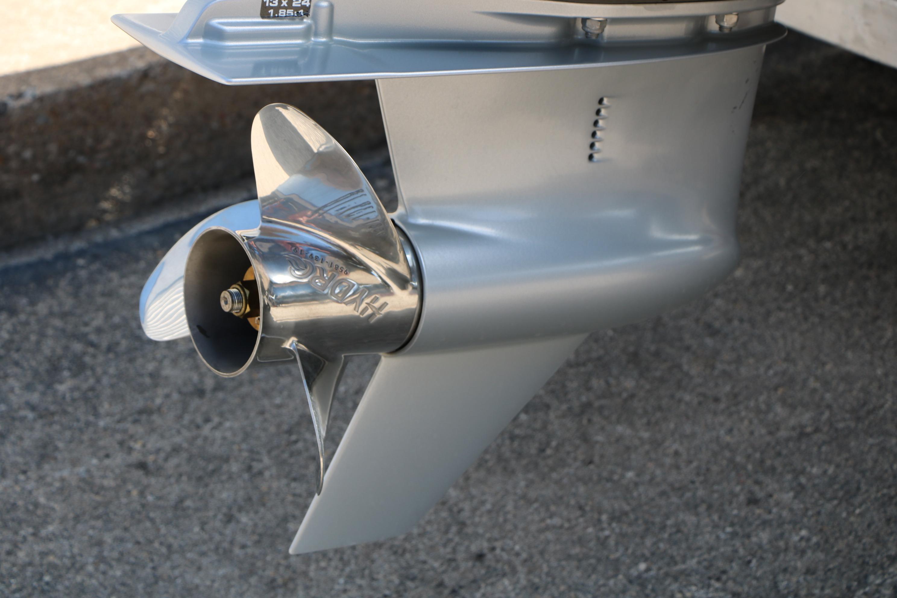 Close-up of a 2023 Alumacraft Competitor FSX 185 boat propeller on concrete surface.