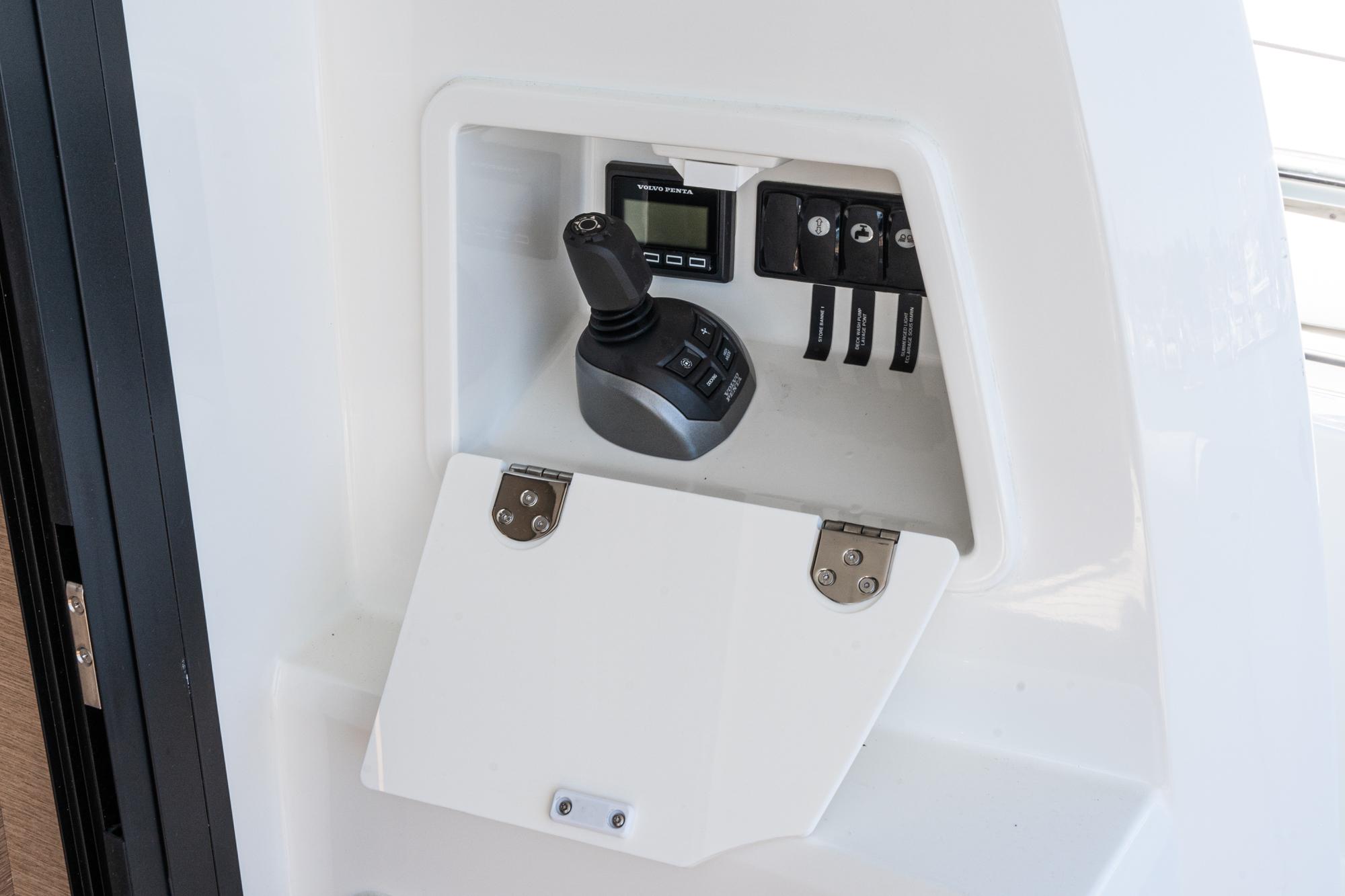 Control panel of a 2022 Prestige 460 yacht with joystick and switches.