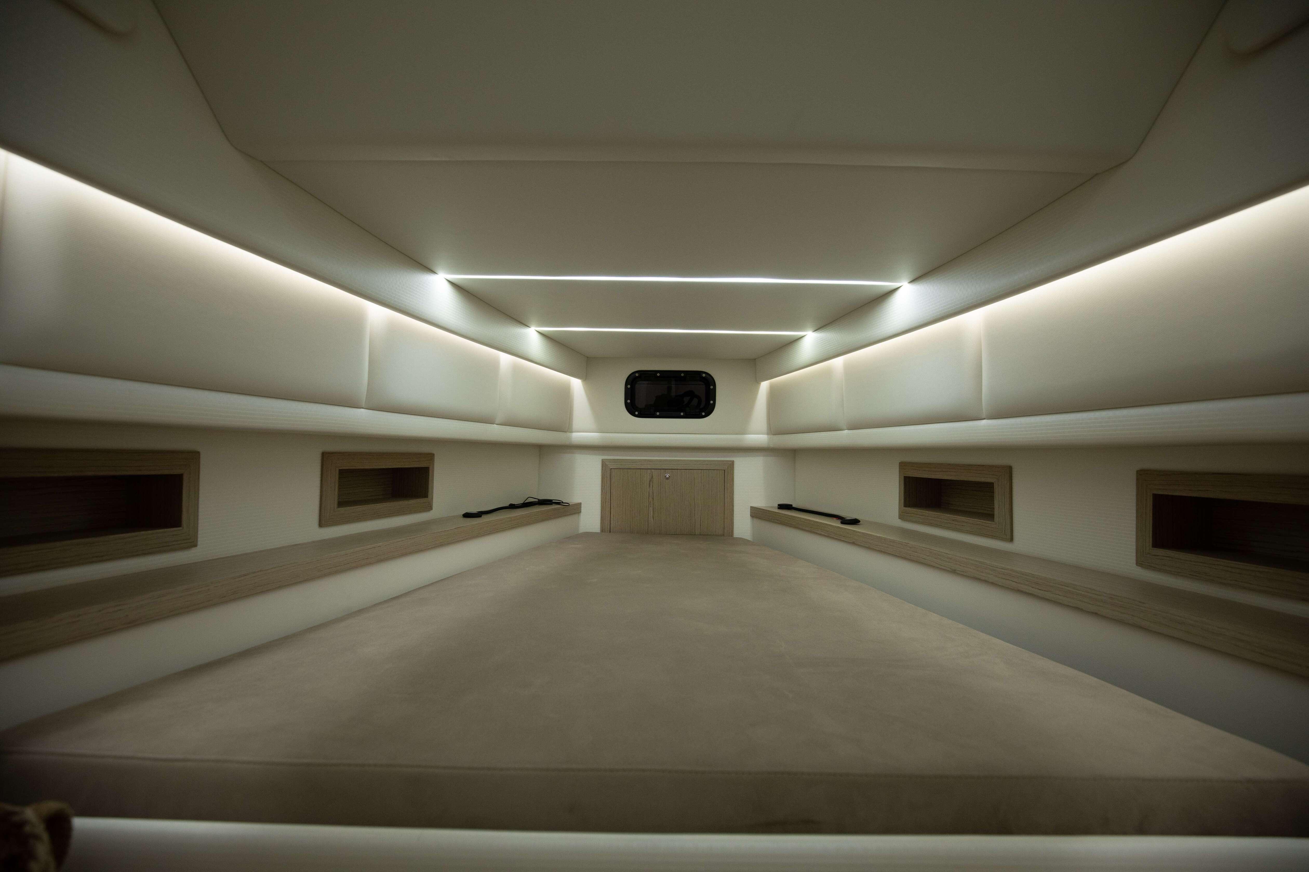 Luxurious interior cabin of 2024 Technohull Omega 47 boat, featuring modern lighting and spacious design.