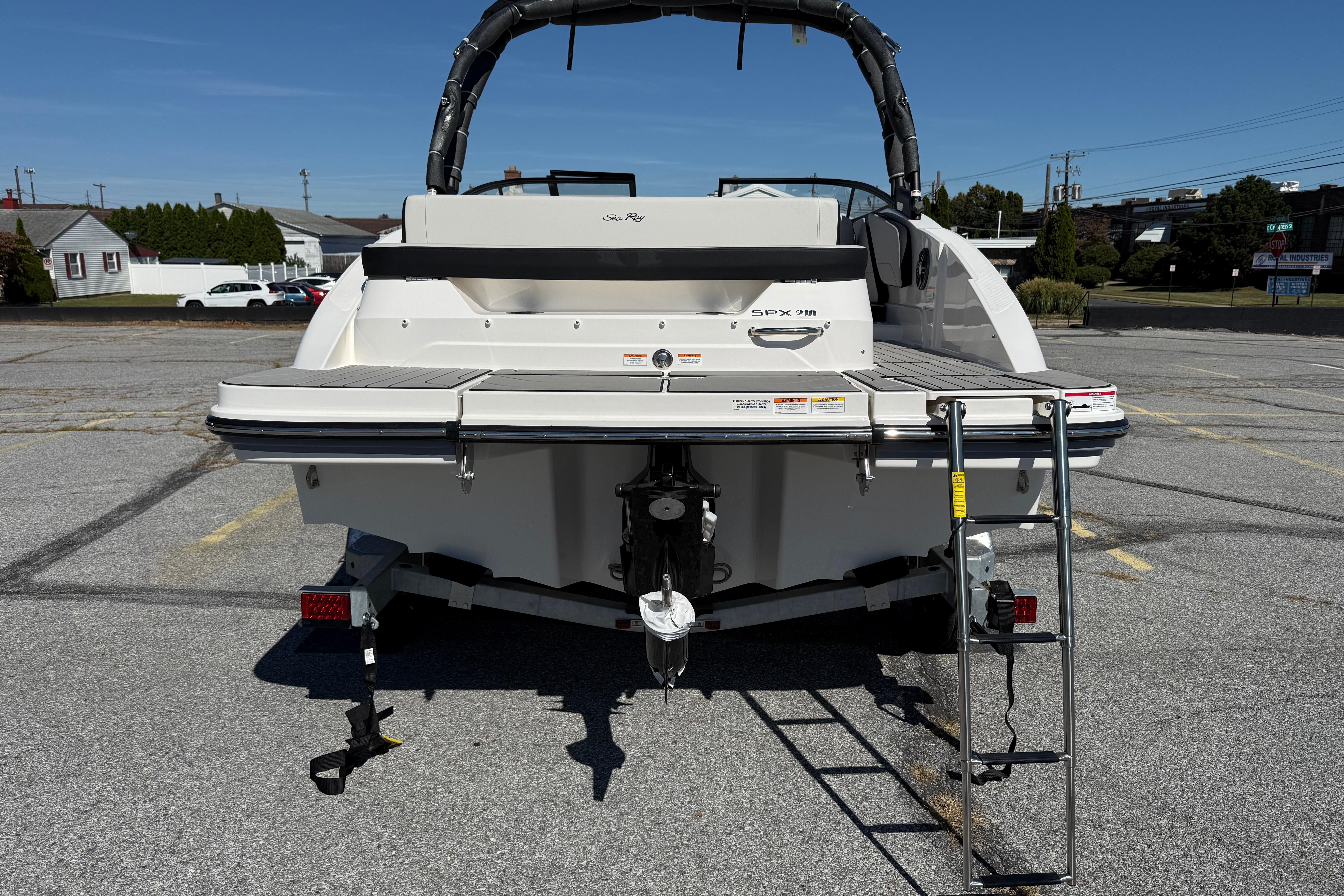 2026 Sea Ray SPX 210 boat rear view with swim platform and ladder.