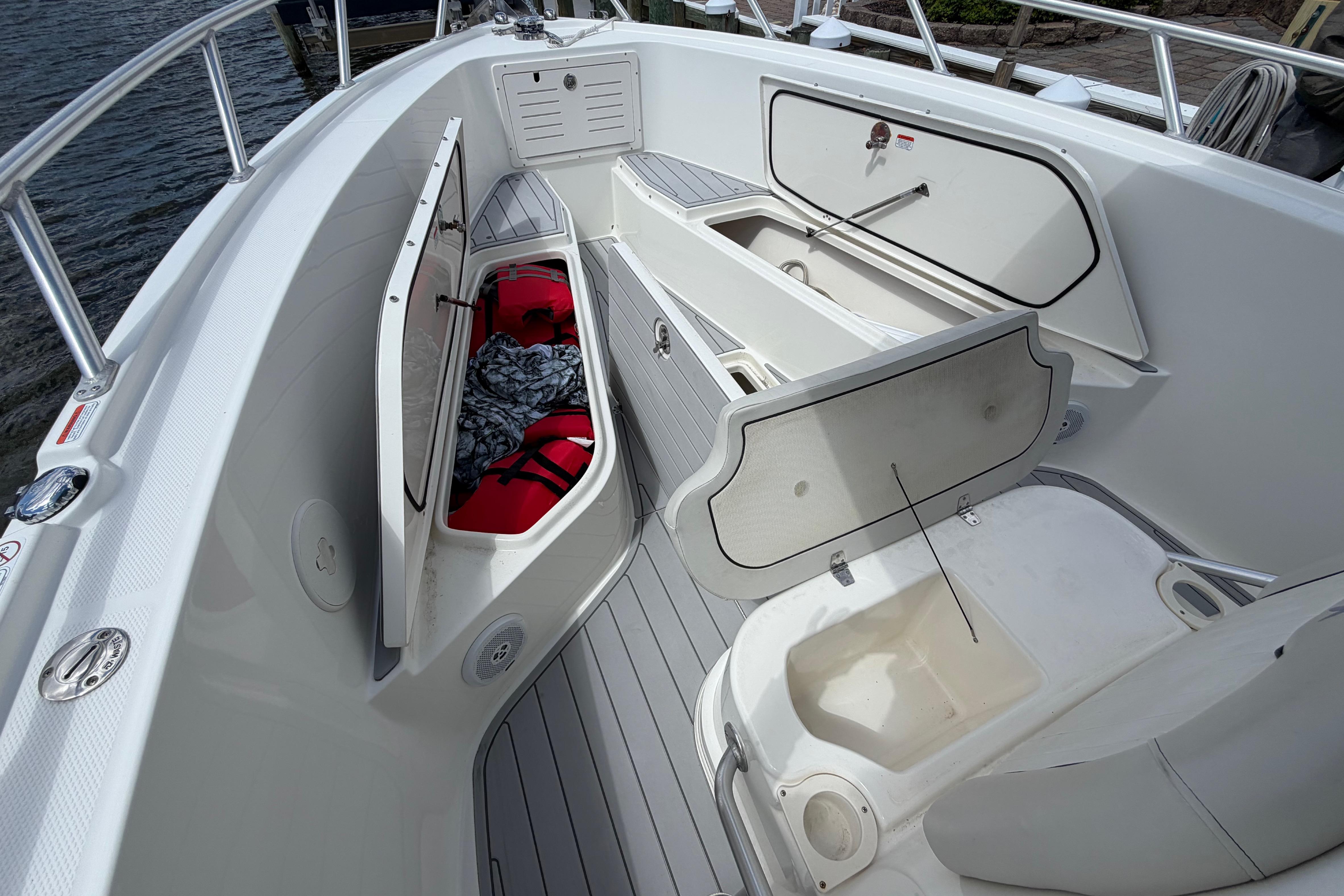 2017 Mako 284 Center Console boat interior with open storage compartments.