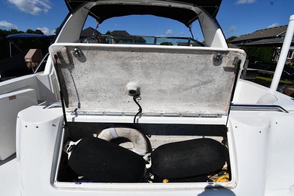 Open storage compartment on 1997 Sea Ray 400 Sundancer boat, showing interior space and equipment.