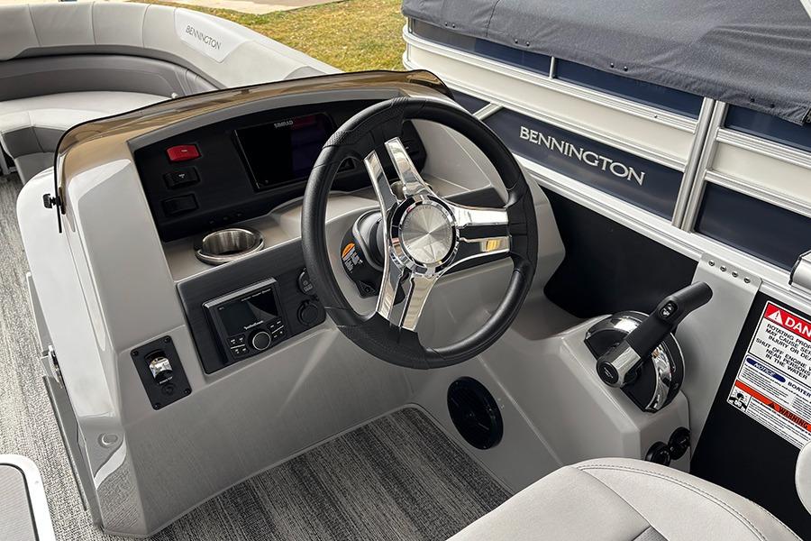 2025 Bennington SX 22 Swingback boat interior with steering wheel and control panel.