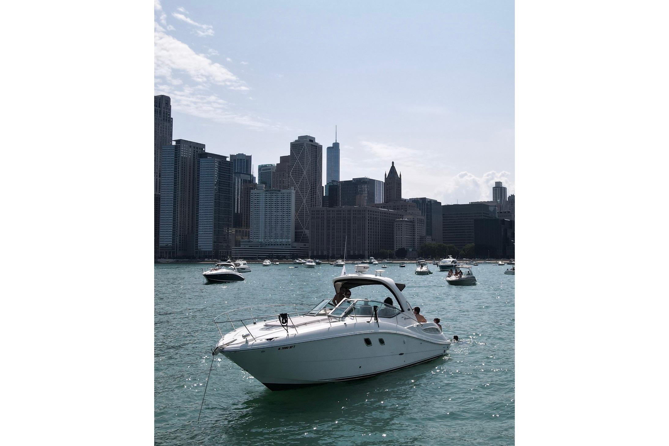 Sea Ray 350 Sundancer 2008 yacht on water with city skyline background.