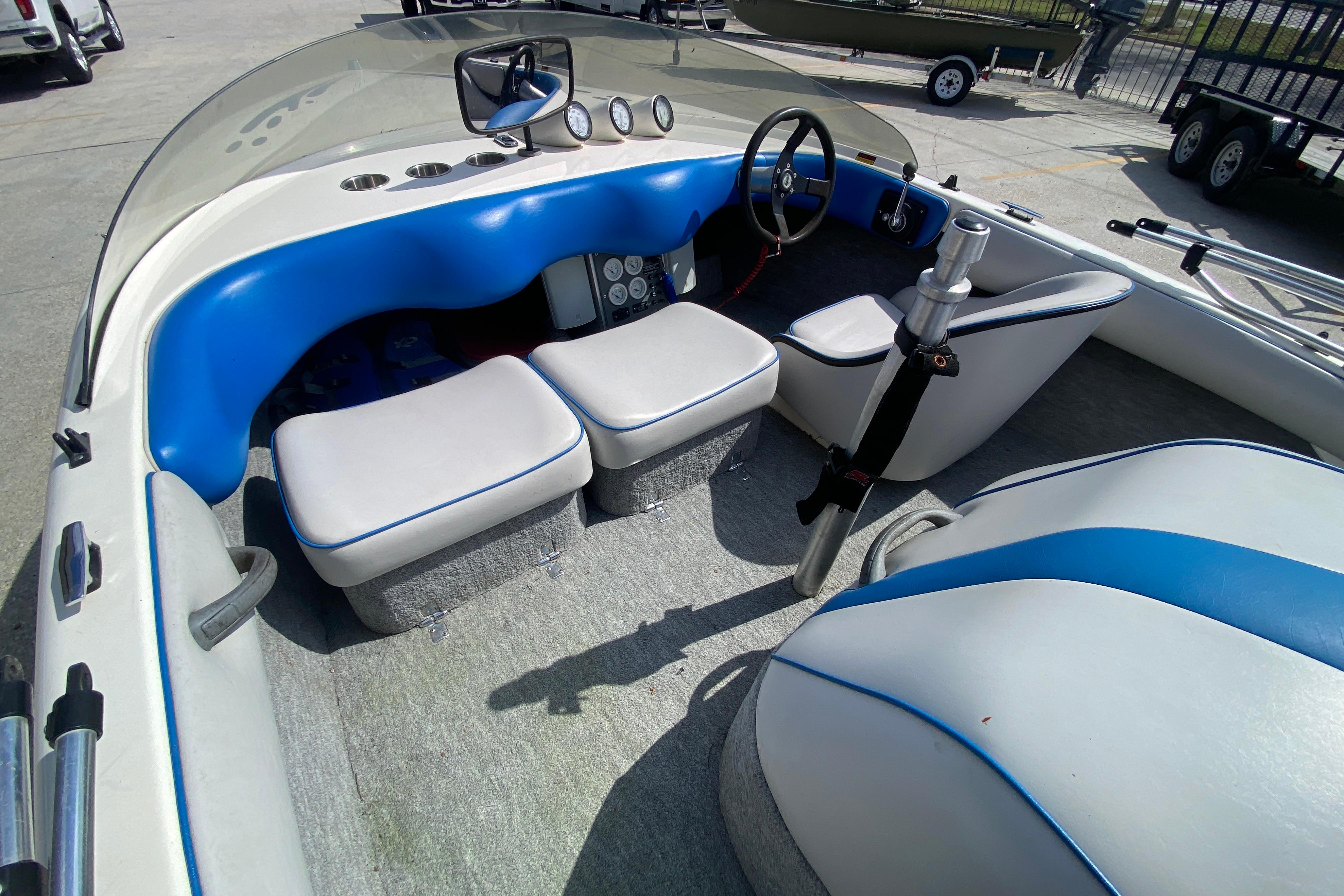 1997 Malibu Tantrum boat interior with blue and white seating and steering wheel.