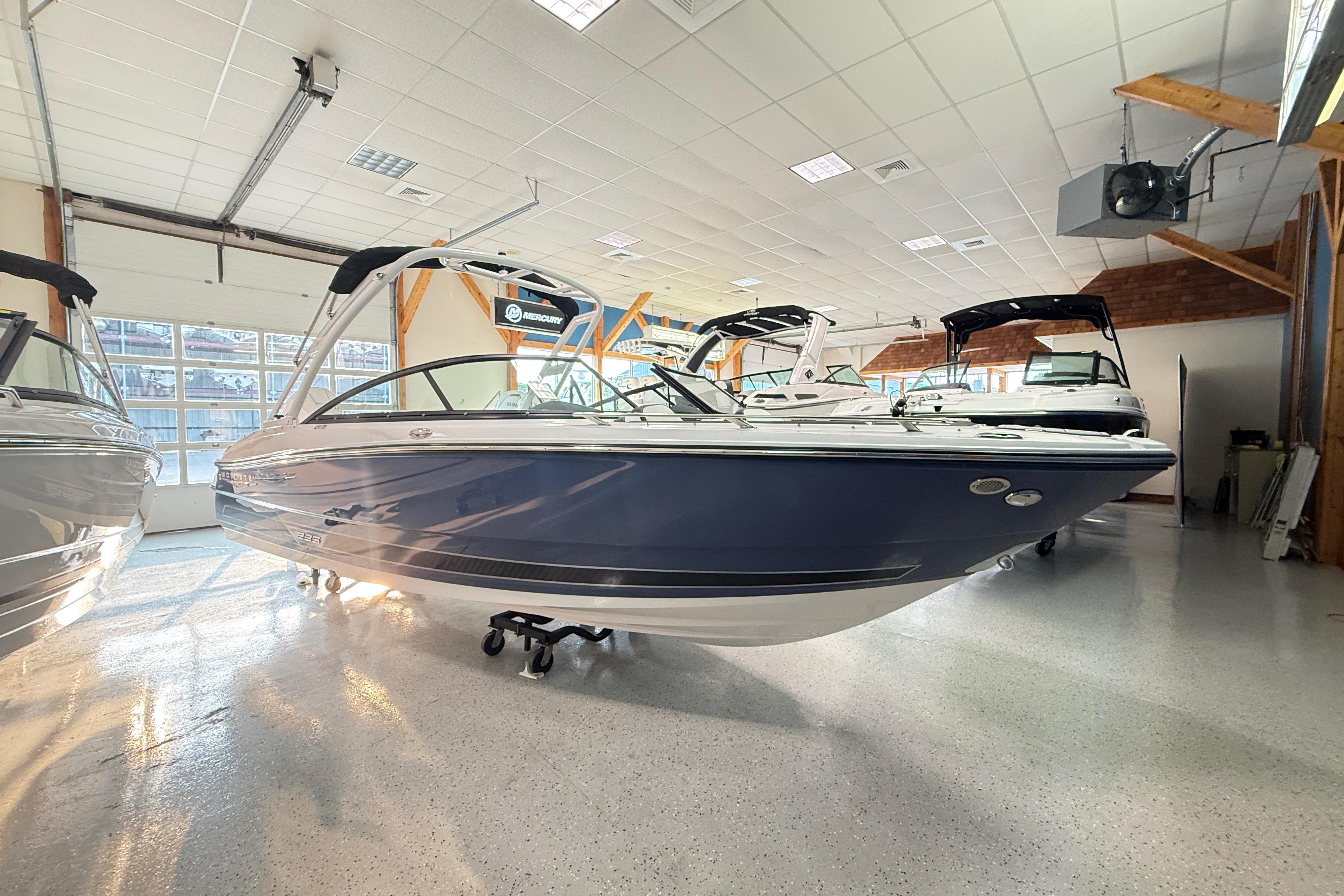 2025 Monterey 235SS Super Sport boat displayed in a showroom.