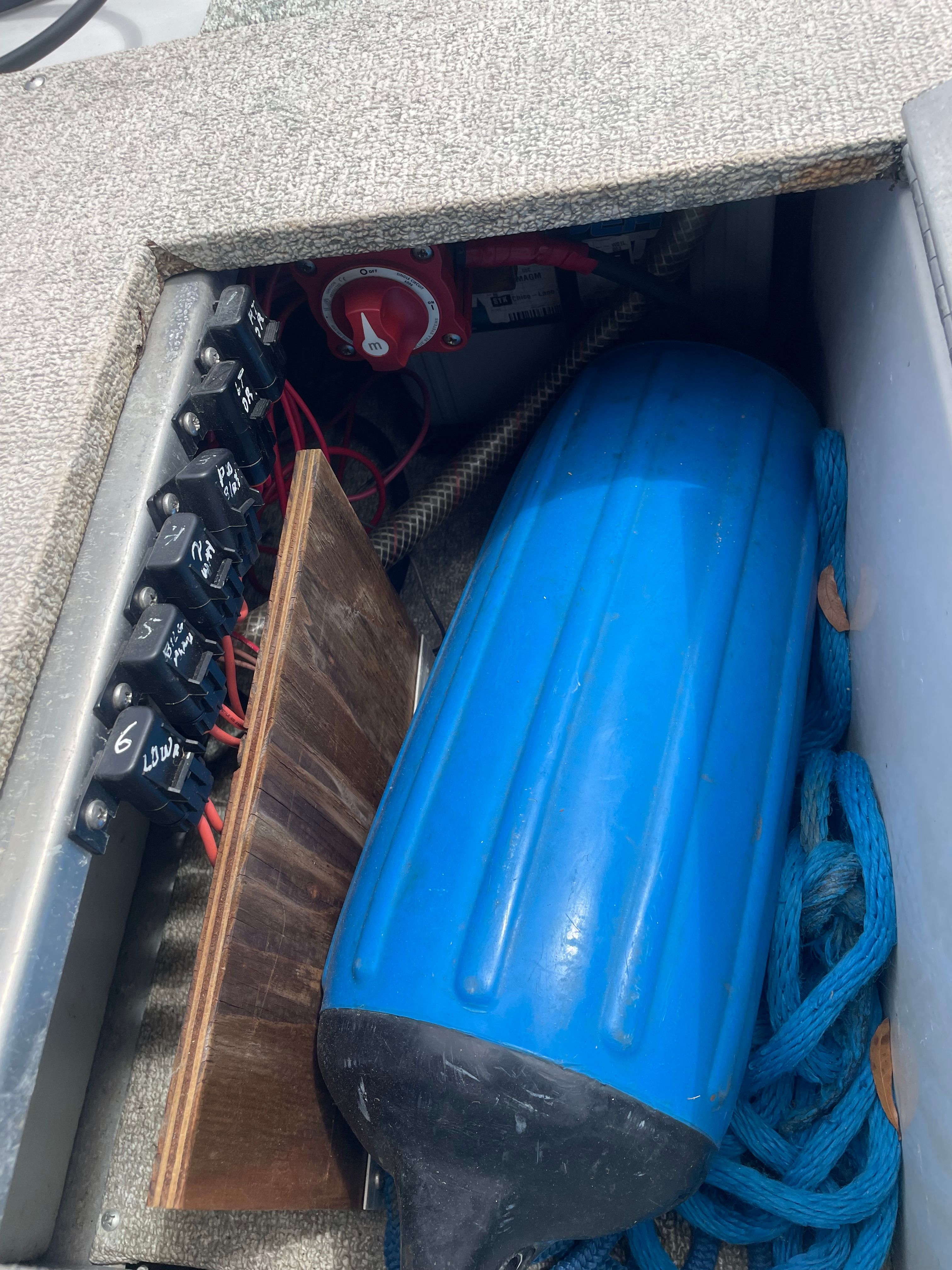 Interior of Crestliner Mirage 2000 boat with blue fender and switches.
