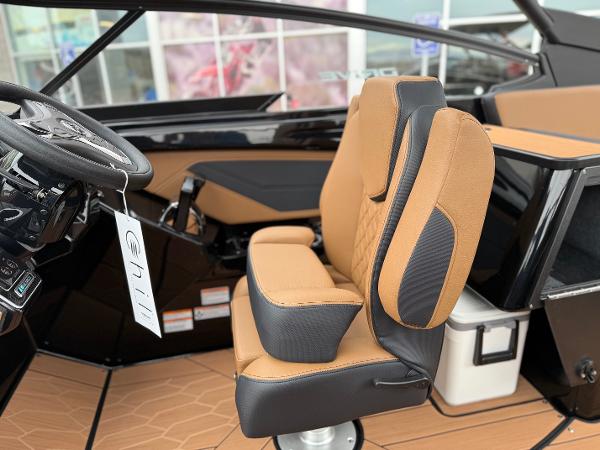 2025 Yamaha Boats 255XD interior with tan and black seating, steering wheel, and modern design.