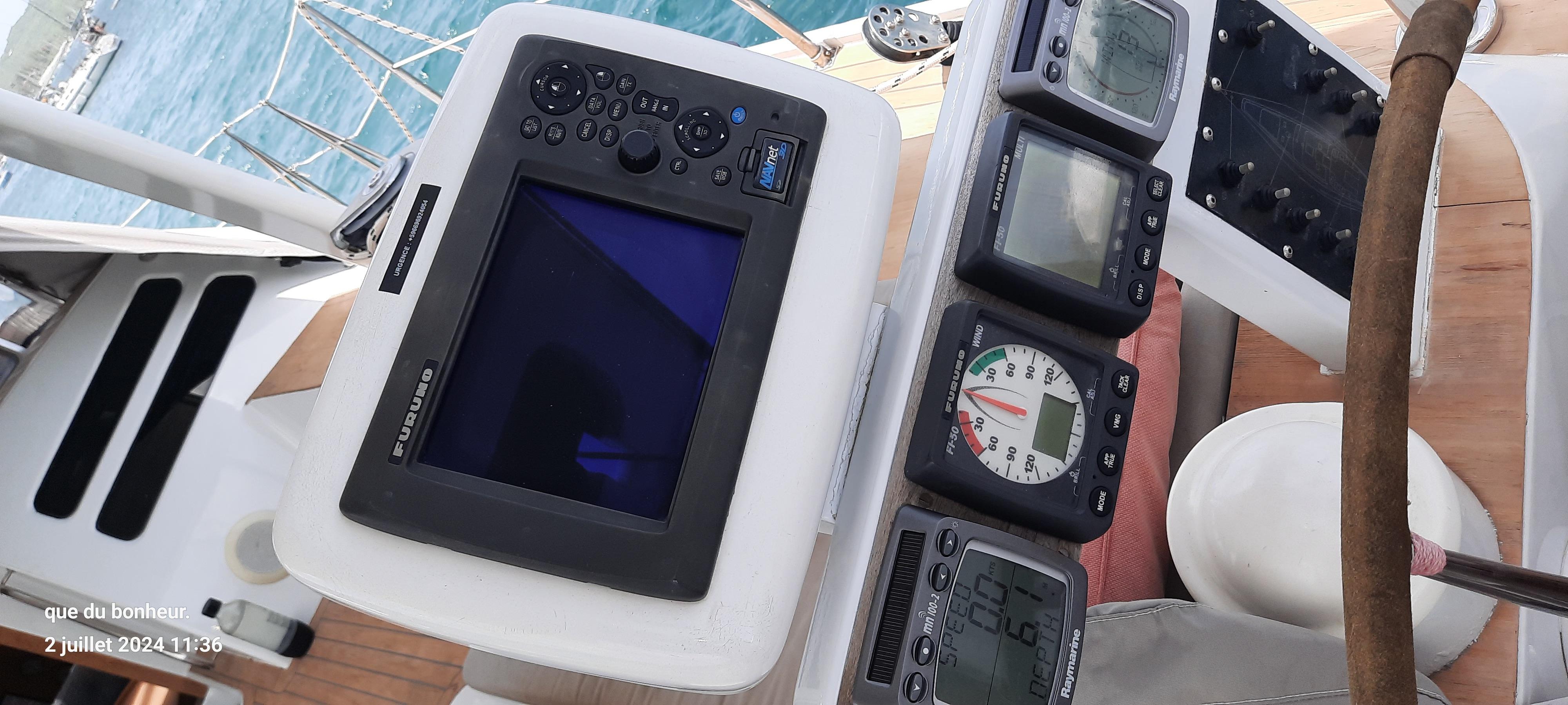 Navigation instruments on a 1993 Wauquiez PS 60 yacht, featuring a central display and gauges.