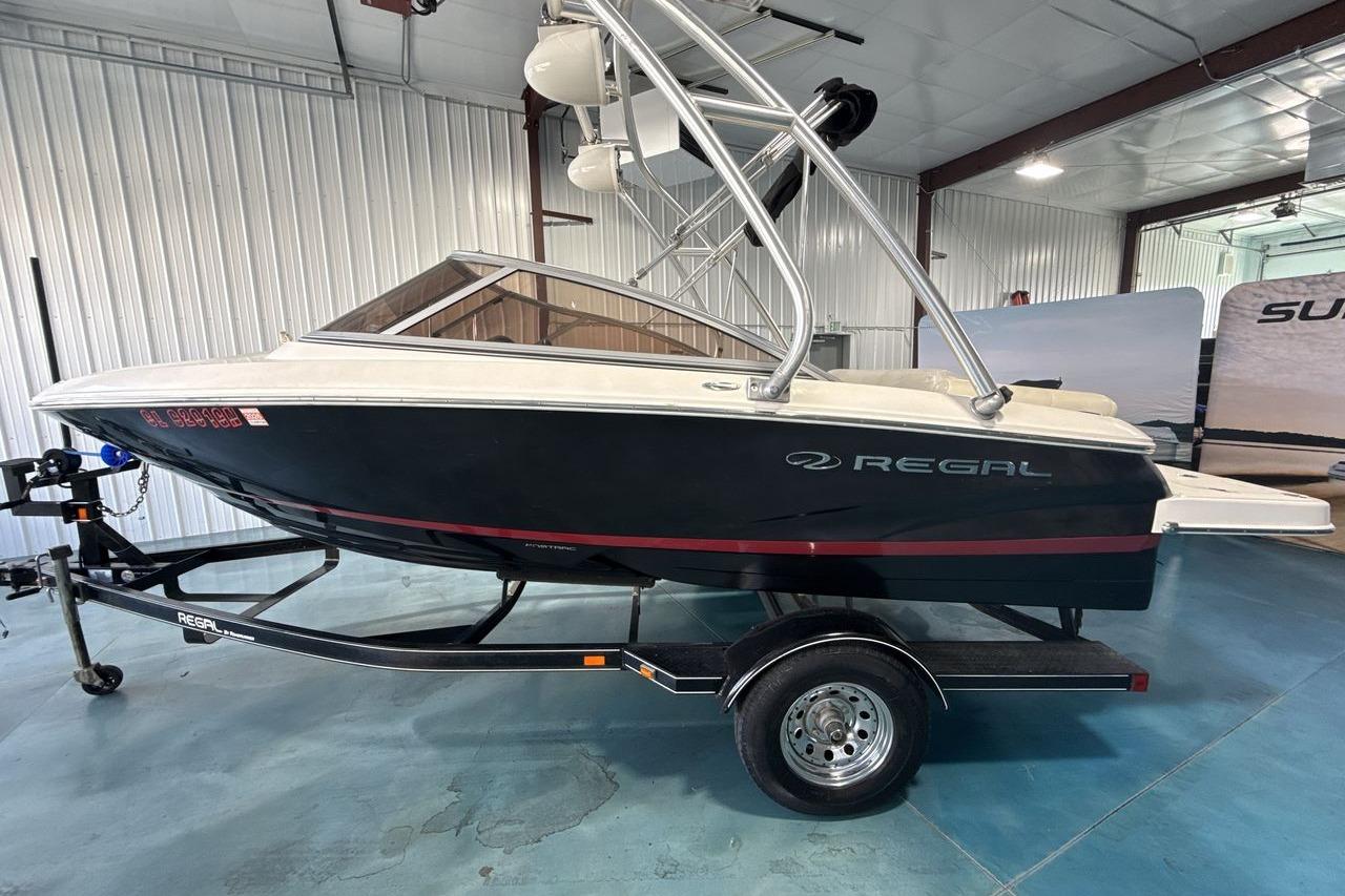 2012 Regal 1900 Bowrider boat on trailer in indoor storage facility.