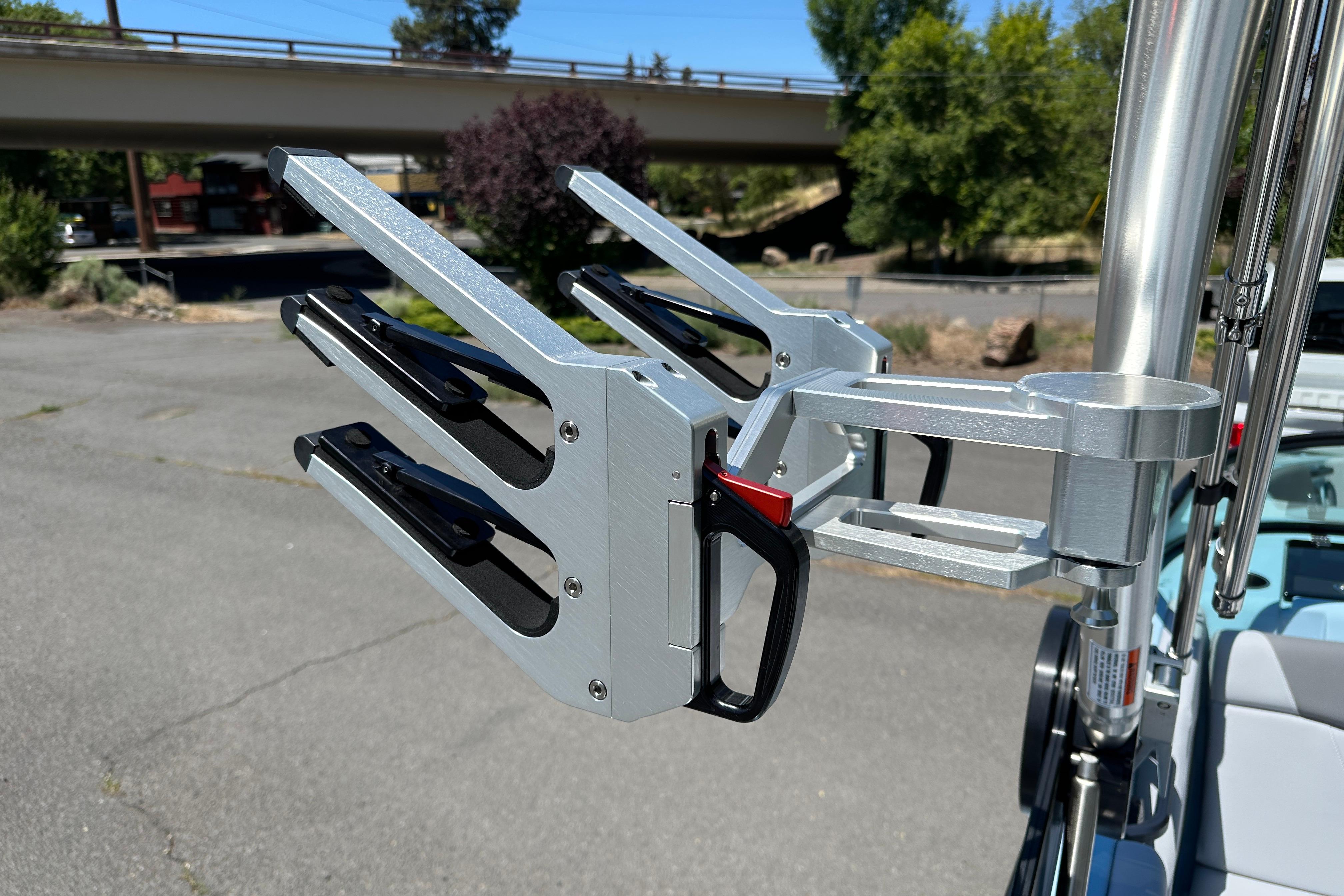 2023 MasterCraft NXT23 wakeboard rack, silver finish, mounted on boat, outdoor setting.