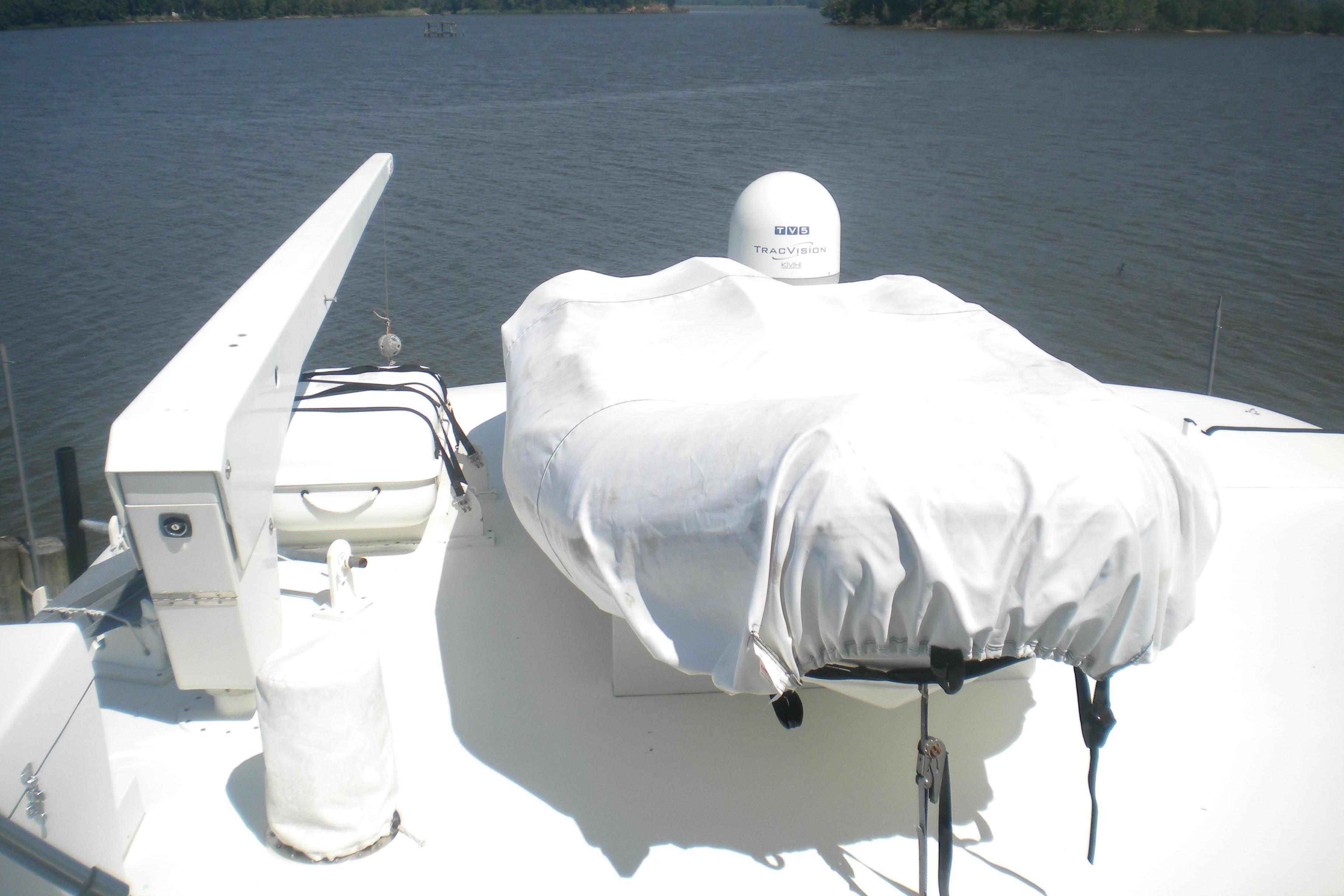 1980 Hatteras 70 Motor Yacht deck with covered equipment and water view.