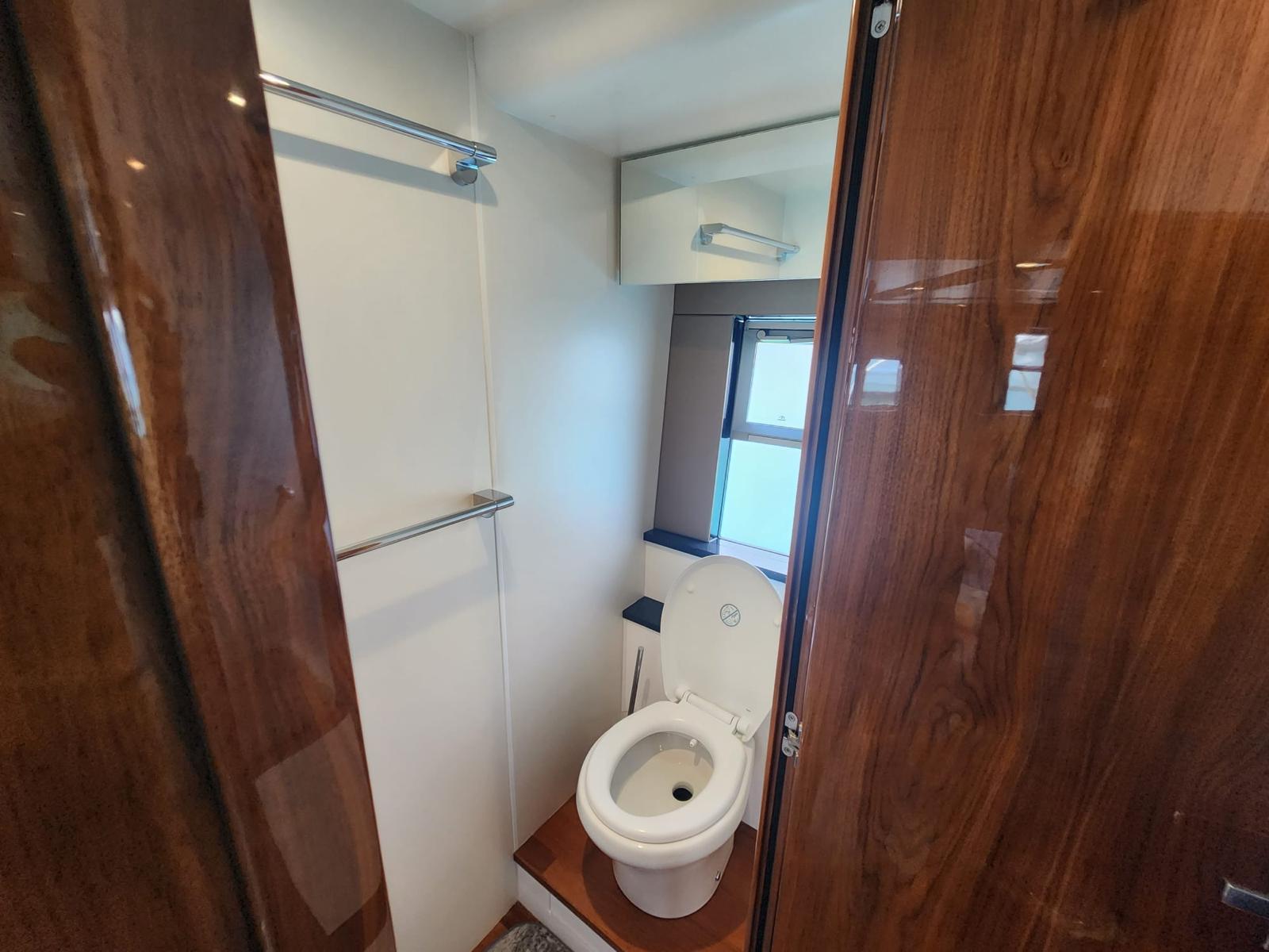 Luxurious bathroom in 2012 Fairline Squadron 65 yacht with wooden finishes and modern amenities.