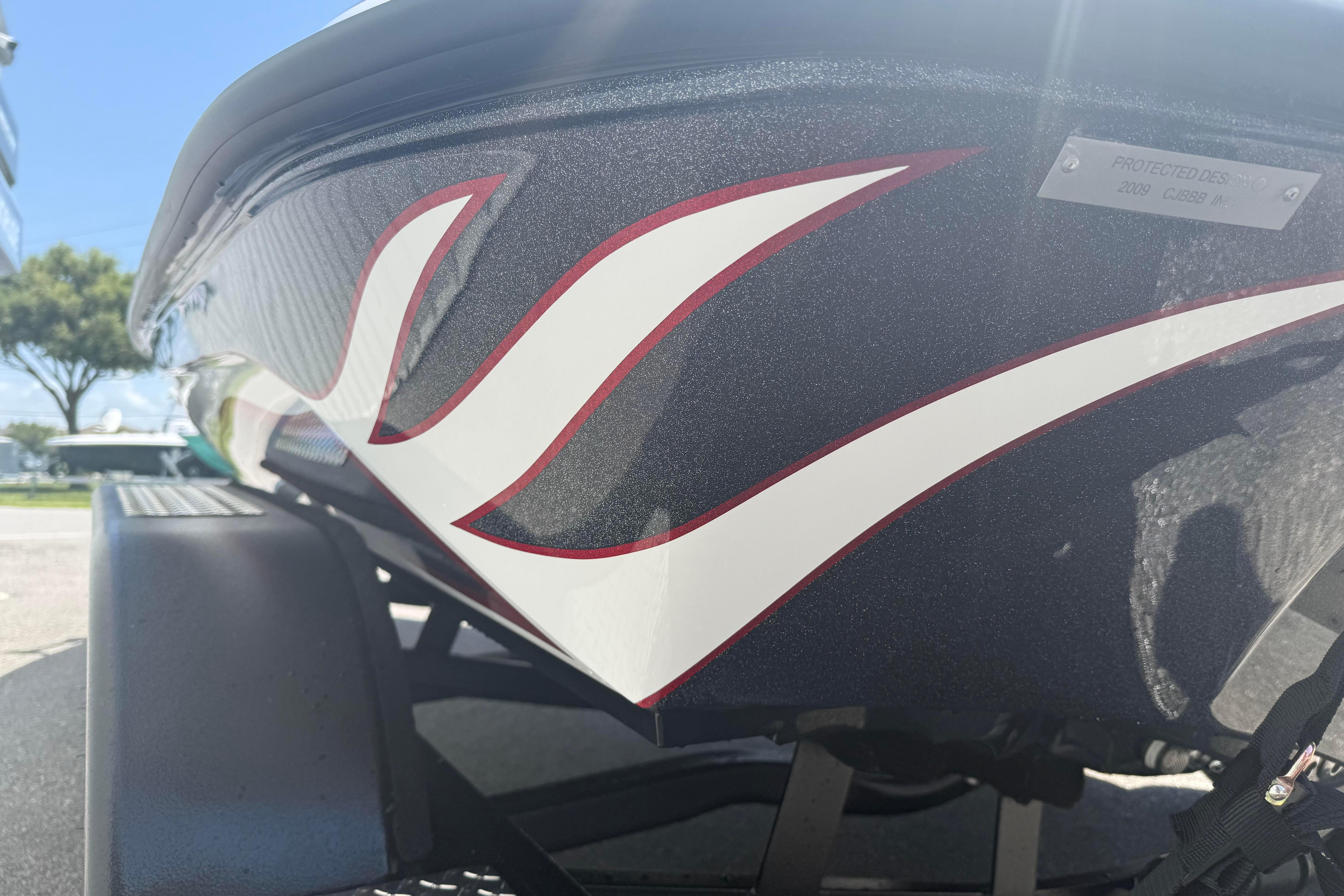 Close-up of 2027 Phoenix 819 ZXL boat with sleek red and white design.