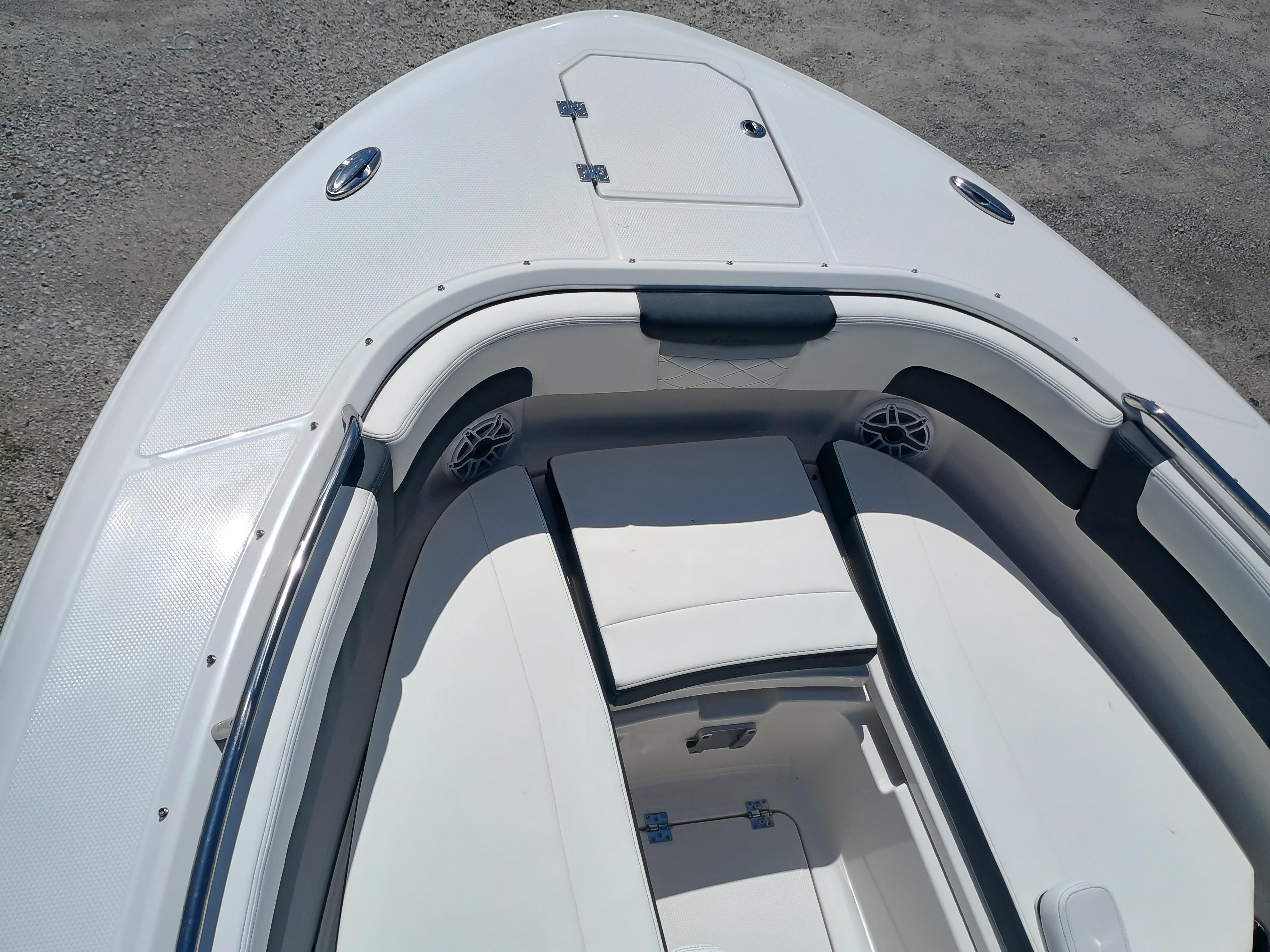 2025 Robalo R257 Dual Console boat interior with white seating and storage compartments.