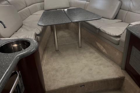 2005 Formula 400 SS cabin interior with seating, table, and kitchenette.