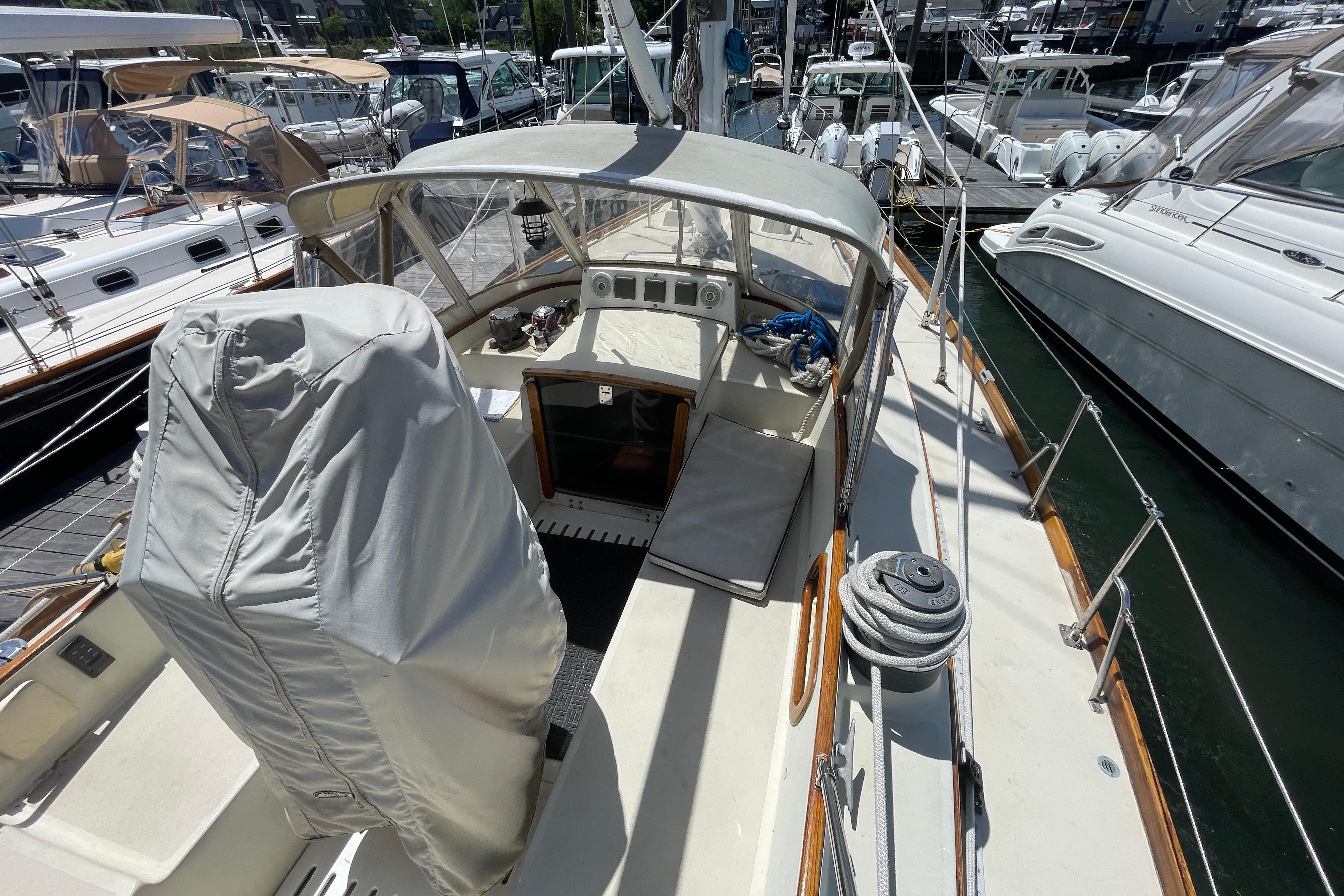 1981 Bristol 41.1 Center Cockpit sailboat docked at marina, featuring covered helm.