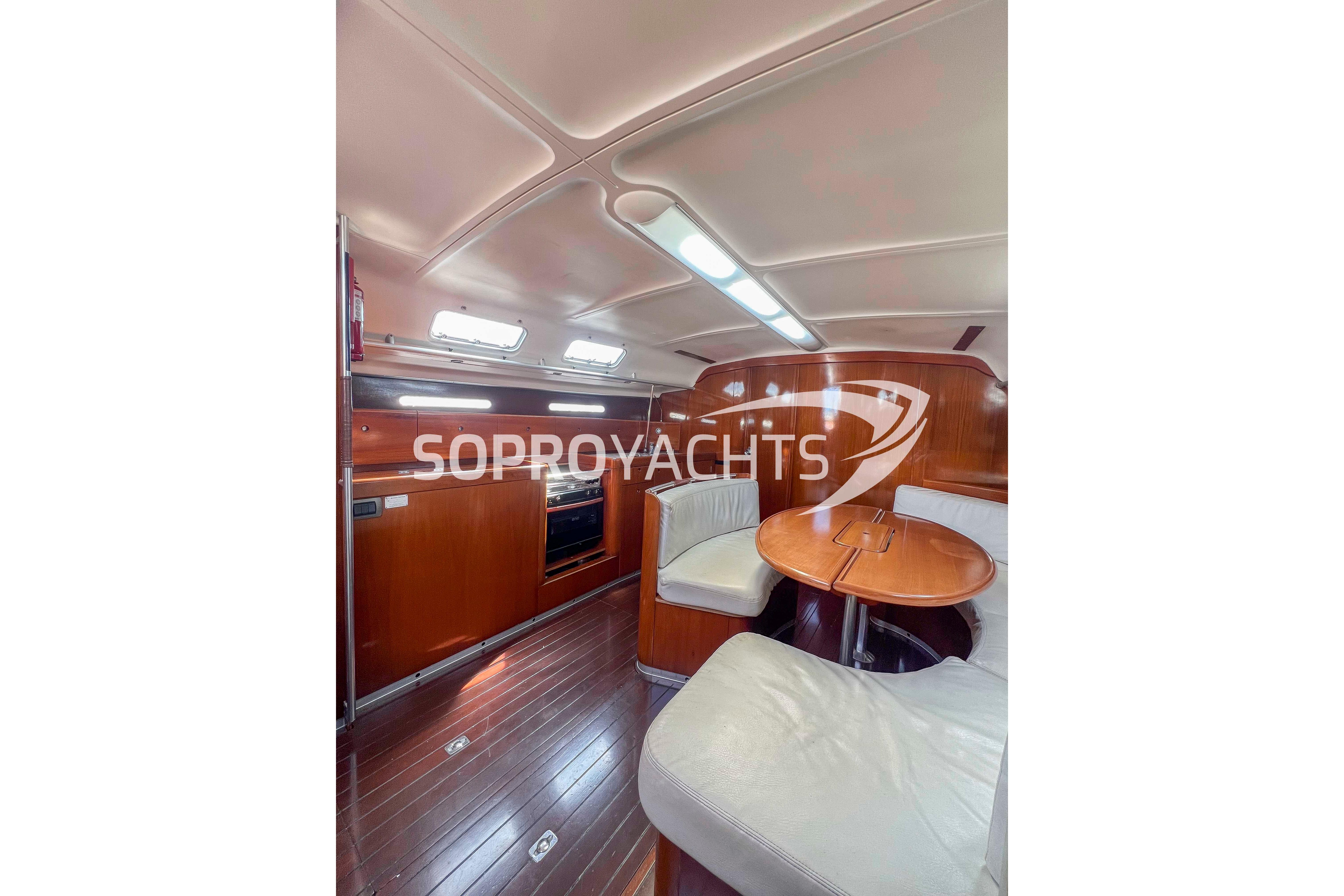 Interior of 1991 Beneteau First 45f5 yacht with wooden finishes and seating area.