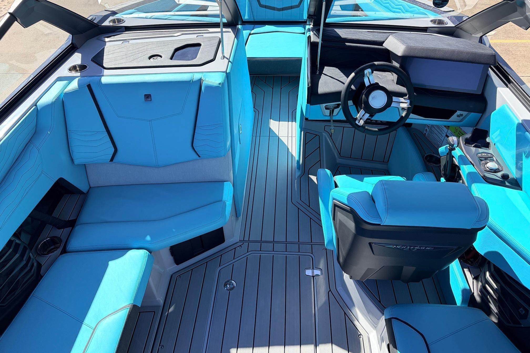2026 Nautique Super Air Nautique G23 interior with blue seating and modern dashboard design.