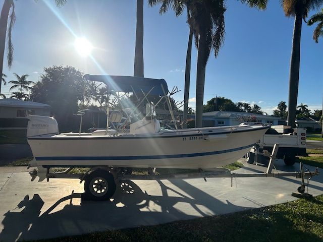 1994 Aquasport Osprey boat on trailer at sunset.