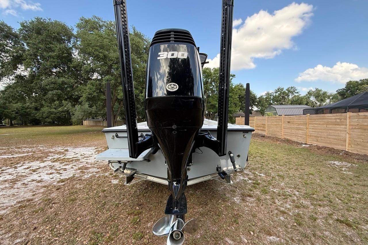 2017 Dorado 25 SE boat with powerful outboard motor, parked on grassy area.