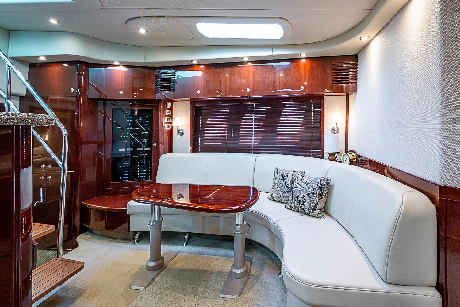 Luxurious interior of 2008 Sea Ray 60 Sundancer yacht with elegant seating and wooden finishes.