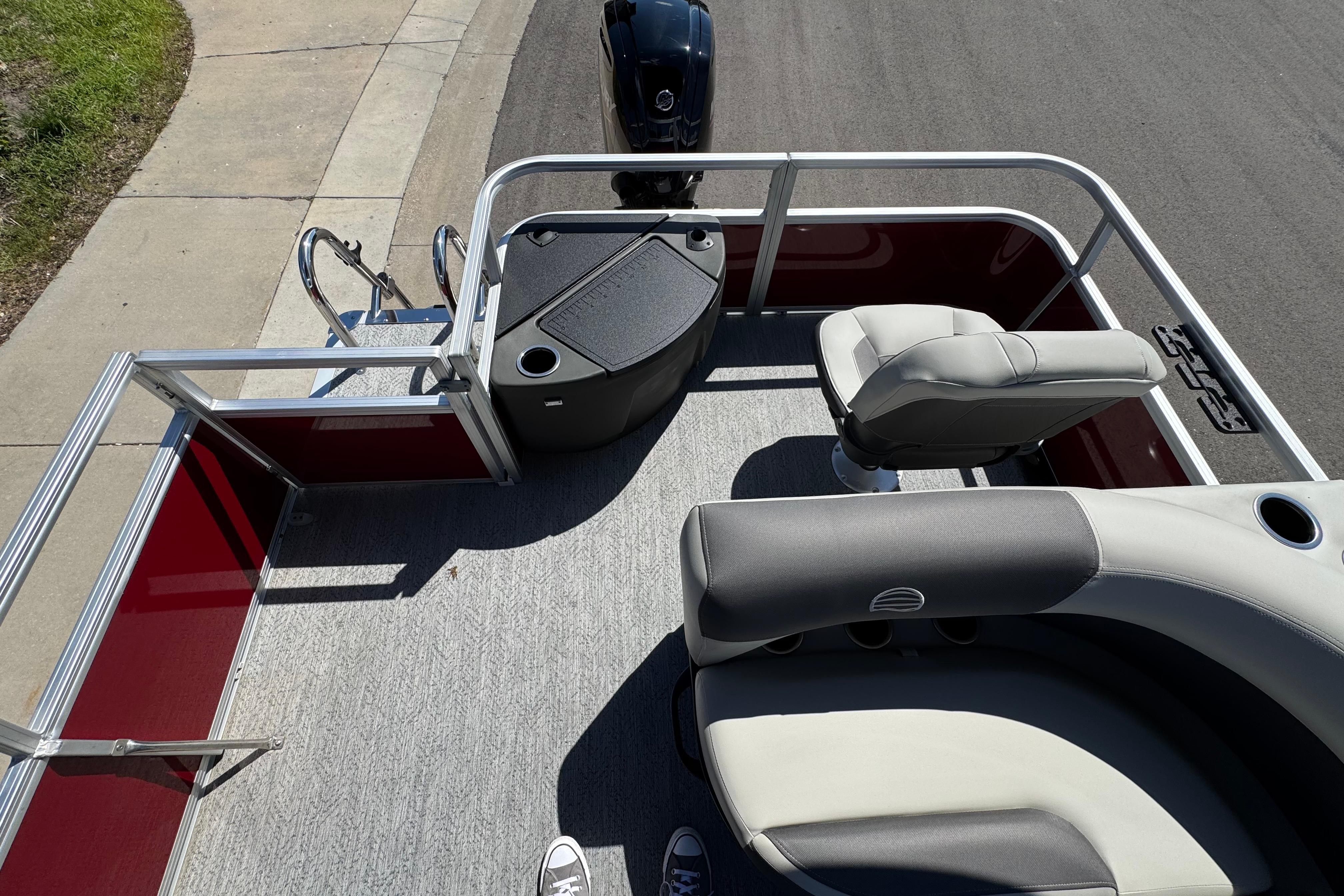 2026 Sun Tracker Bass Buggy 18 DLX pontoon boat interior with seating and railing.