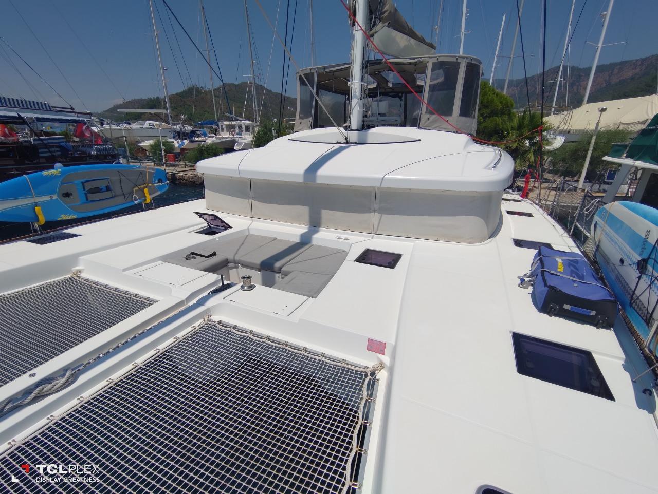 2014 Lagoon 52 catamaran deck with netting, docked at marina.
