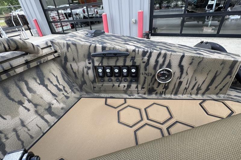 Control panel of 2026 Excel 183 Tomahawk boat with camouflage design and hexagonal floor pattern.