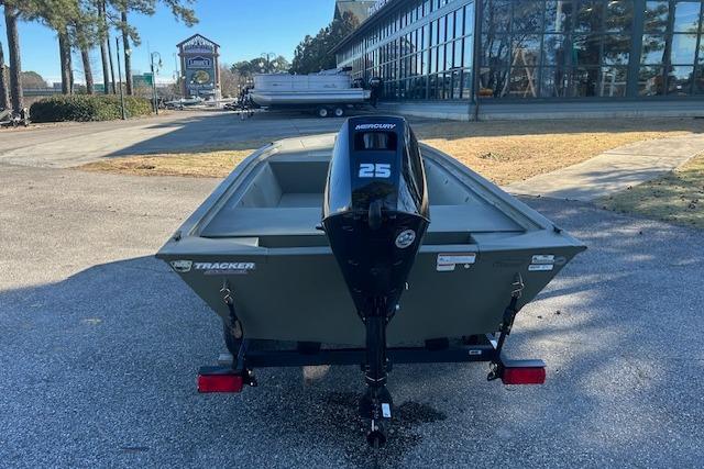 2026 Tracker Grizzly 1648 Utility boat with Mercury 25 engine, parked outdoors.