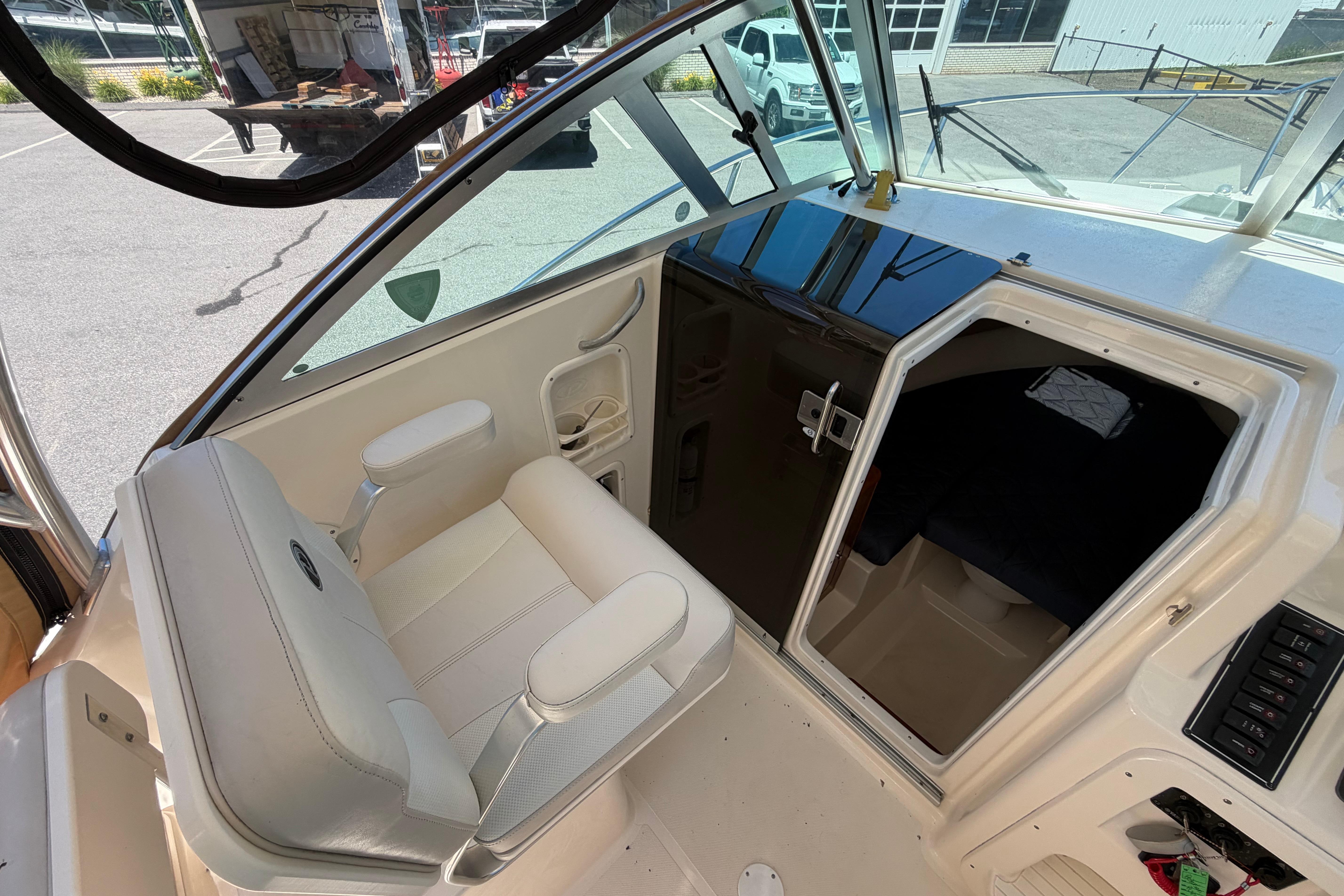 2010 Pursuit OS 255 Offshore boat interior with seating and cabin entrance.