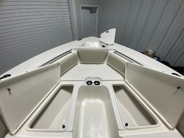 2024 Key West 219 FS boat with open storage compartments.