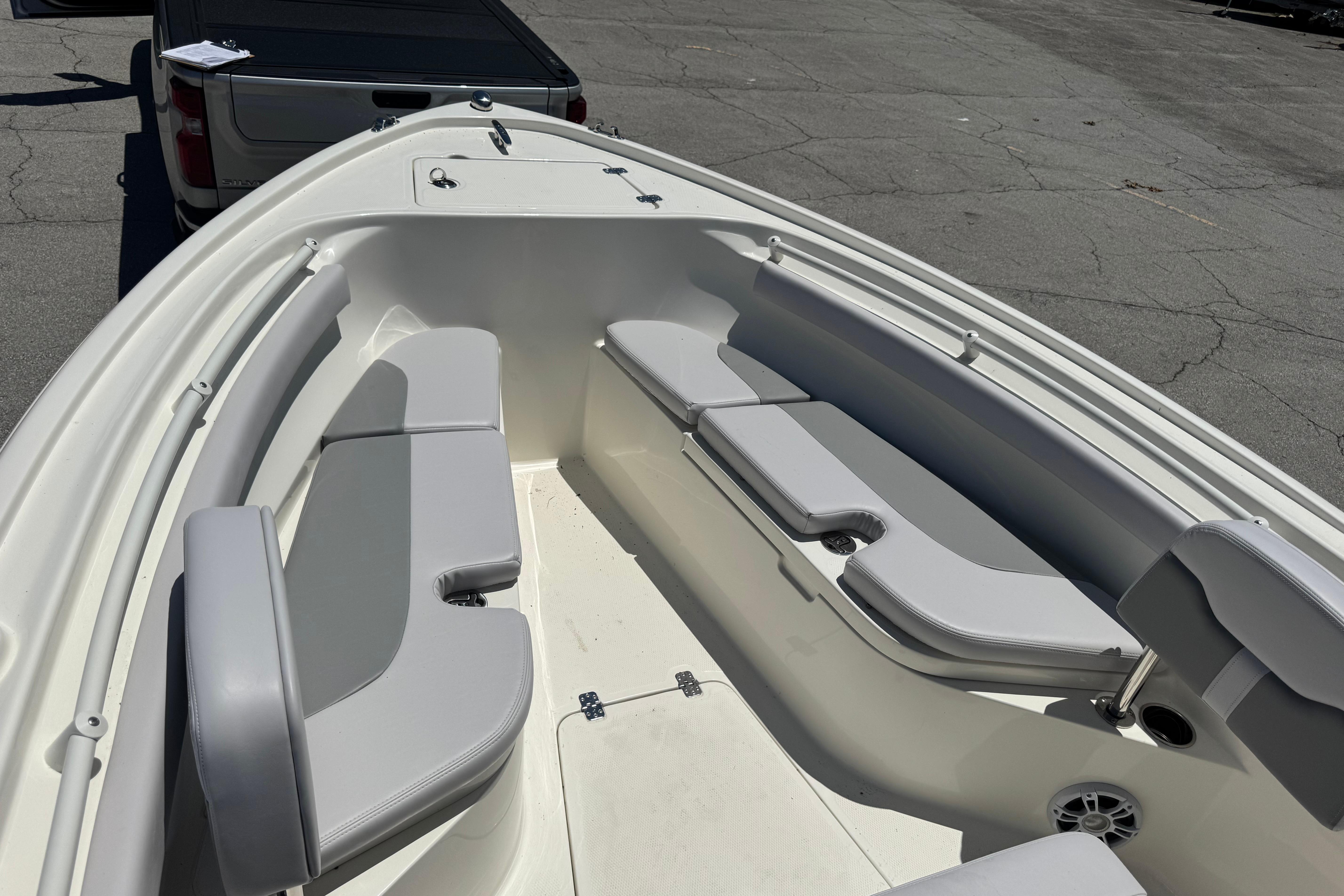 2026 Mako 214 Center Console boat interior with gray seating and spacious layout.