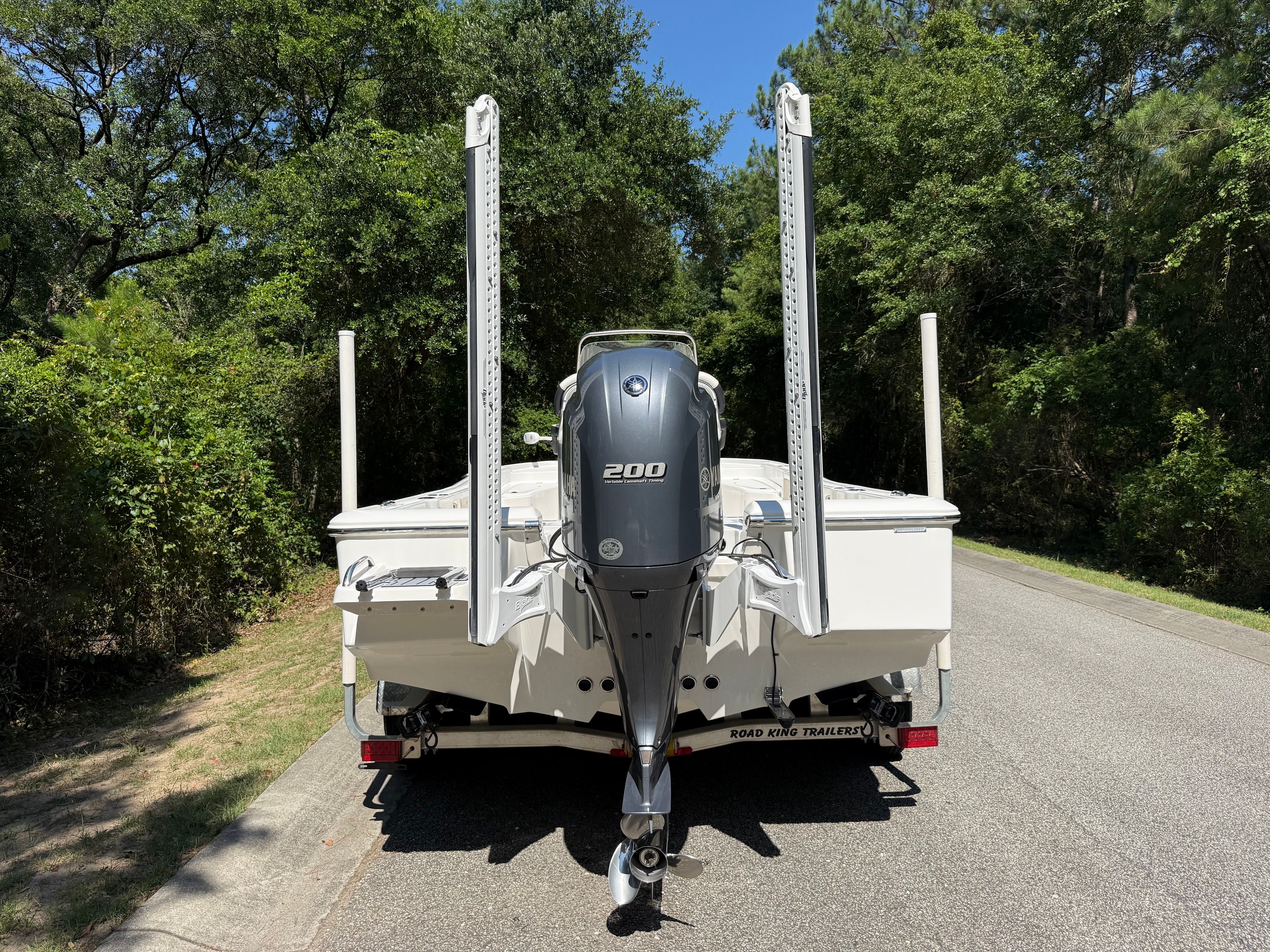 The image shows a Tidewater 2210 Carolina Bay boat from the rear on a trailer.