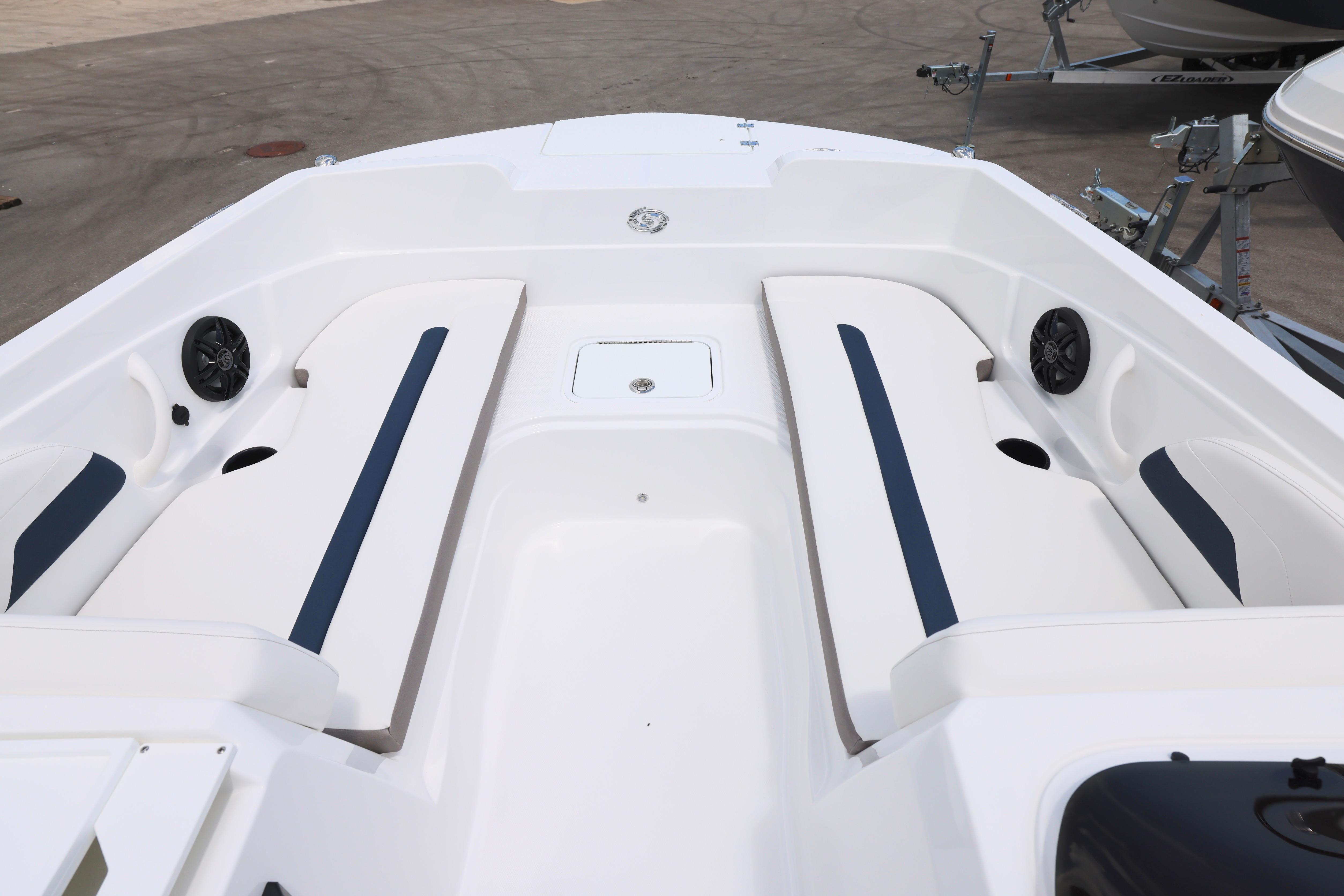 2026 Hurricane SunDeck Sport 205 OB boat interior with white seating and blue accents.