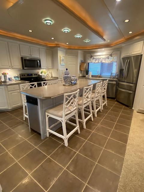 Spacious kitchen in a 2006 Fantasy Houseboat with modern appliances and island seating.