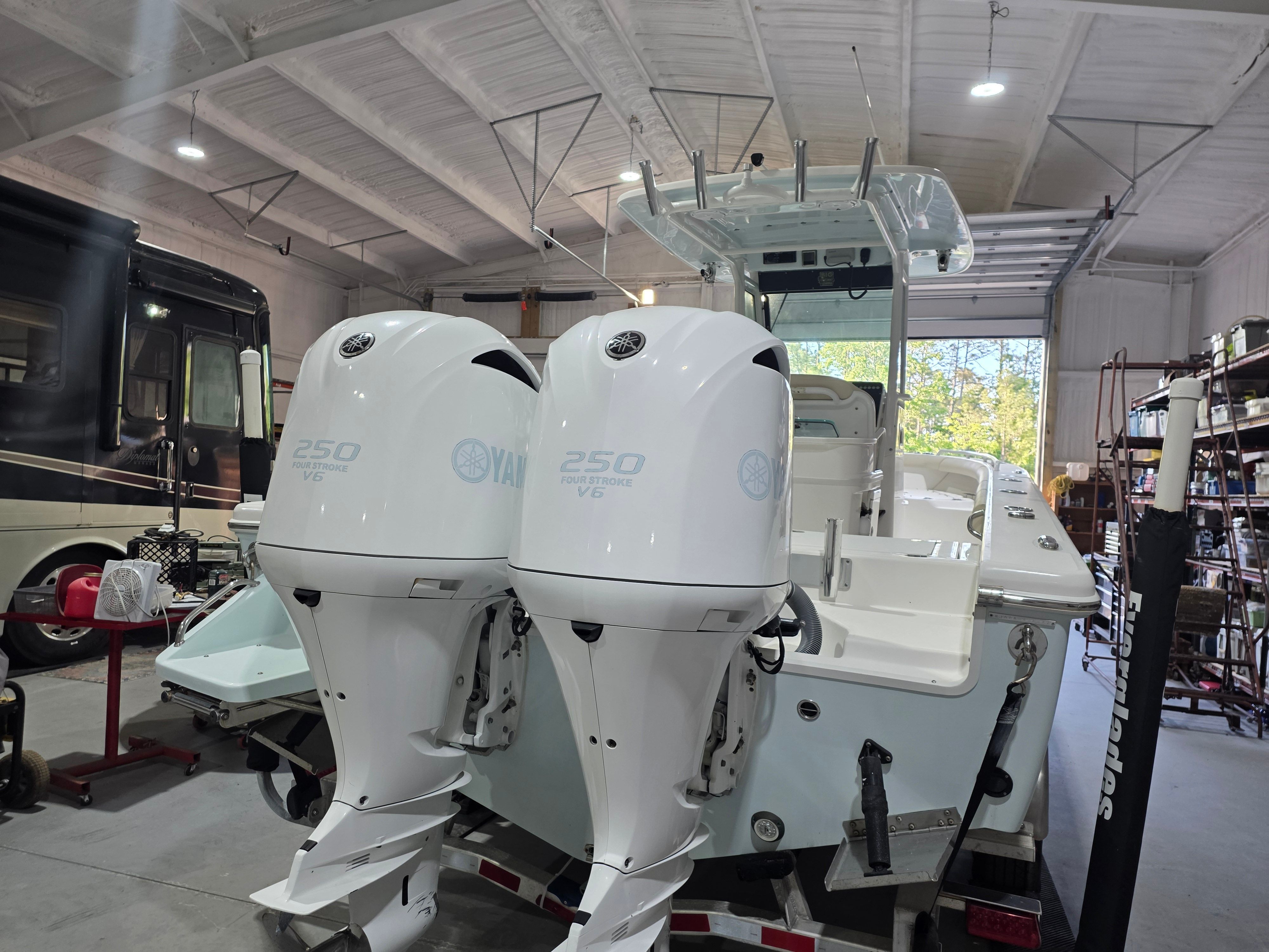 2017 Everglades 273 Center Console with twin Yamaha 250 V6 engines in a storage facility.