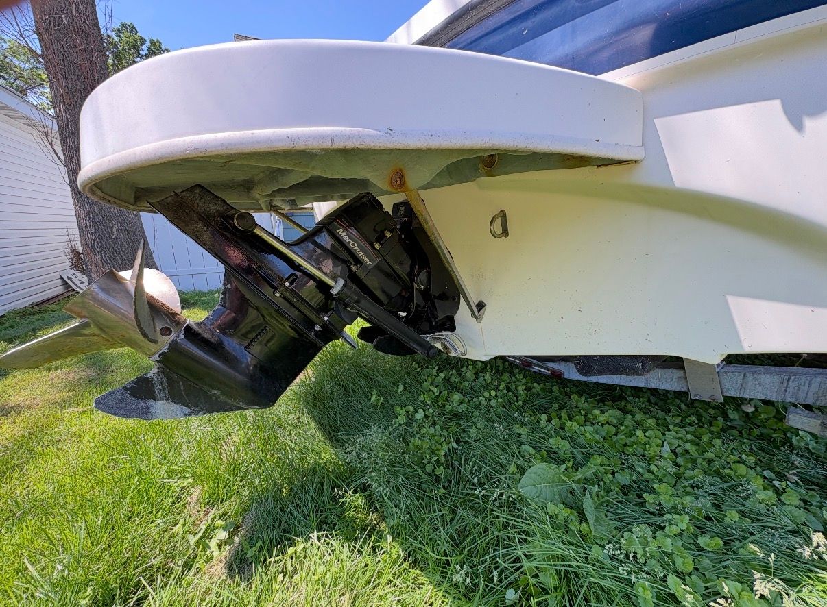 Close-up of the stern of a 2005 Bayliner 212 Open Bow with an outboard motor.