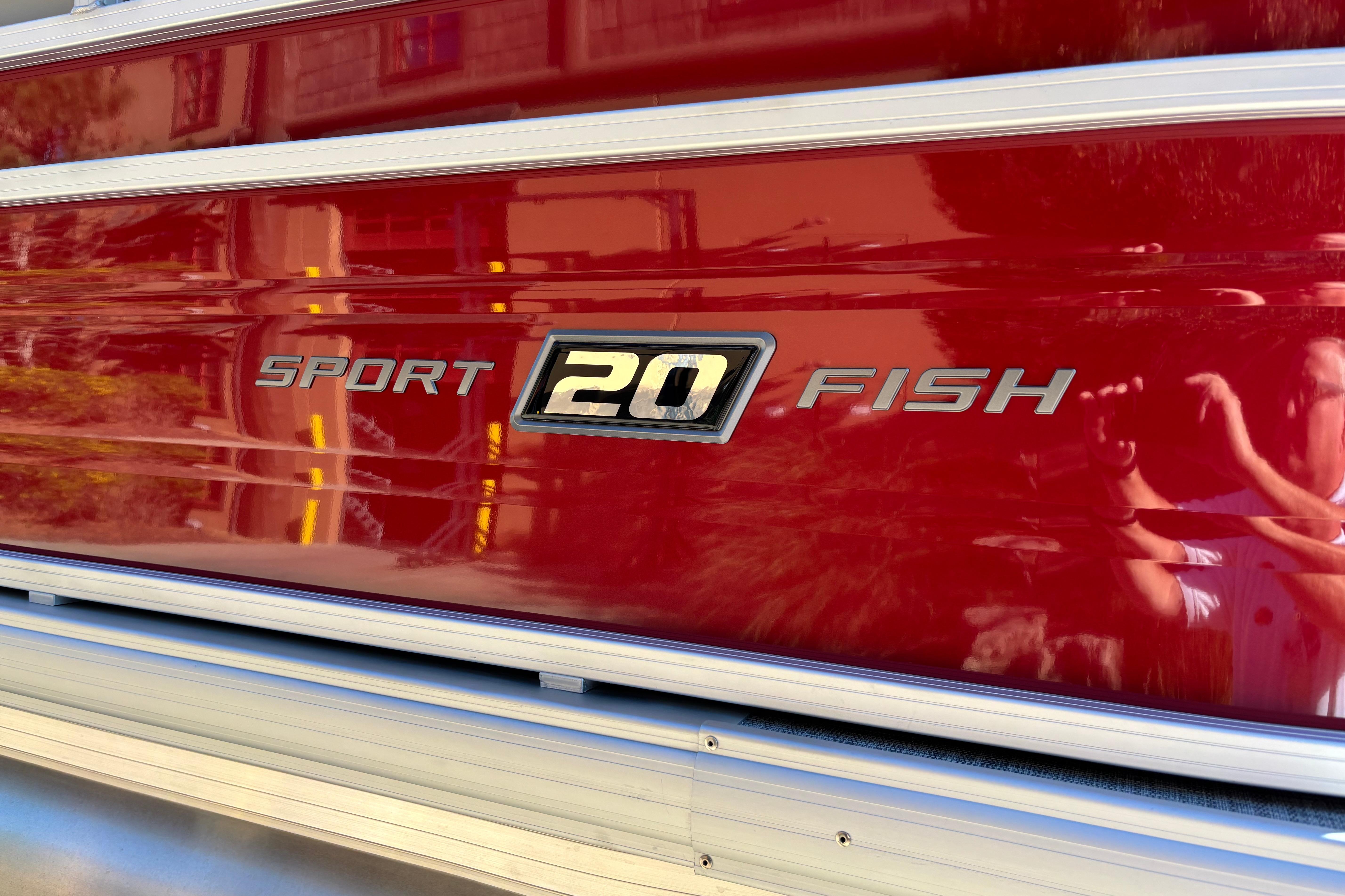 2026 Sun Tracker SportFish 20 DLX boat logo on red exterior.