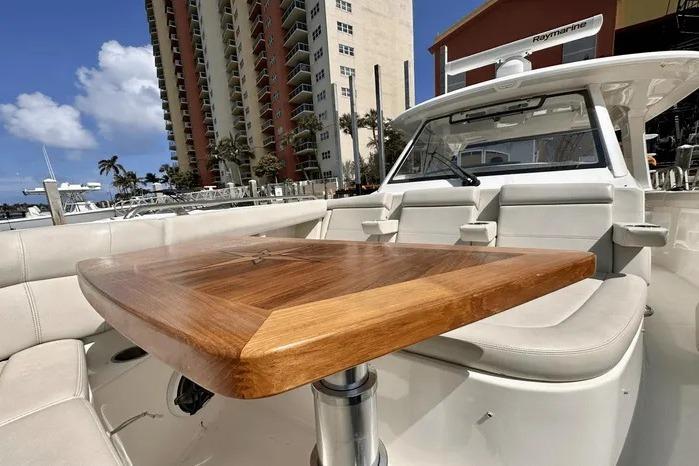 2019 Boston Whaler 350 Realm boat interior with wooden table and seating.
