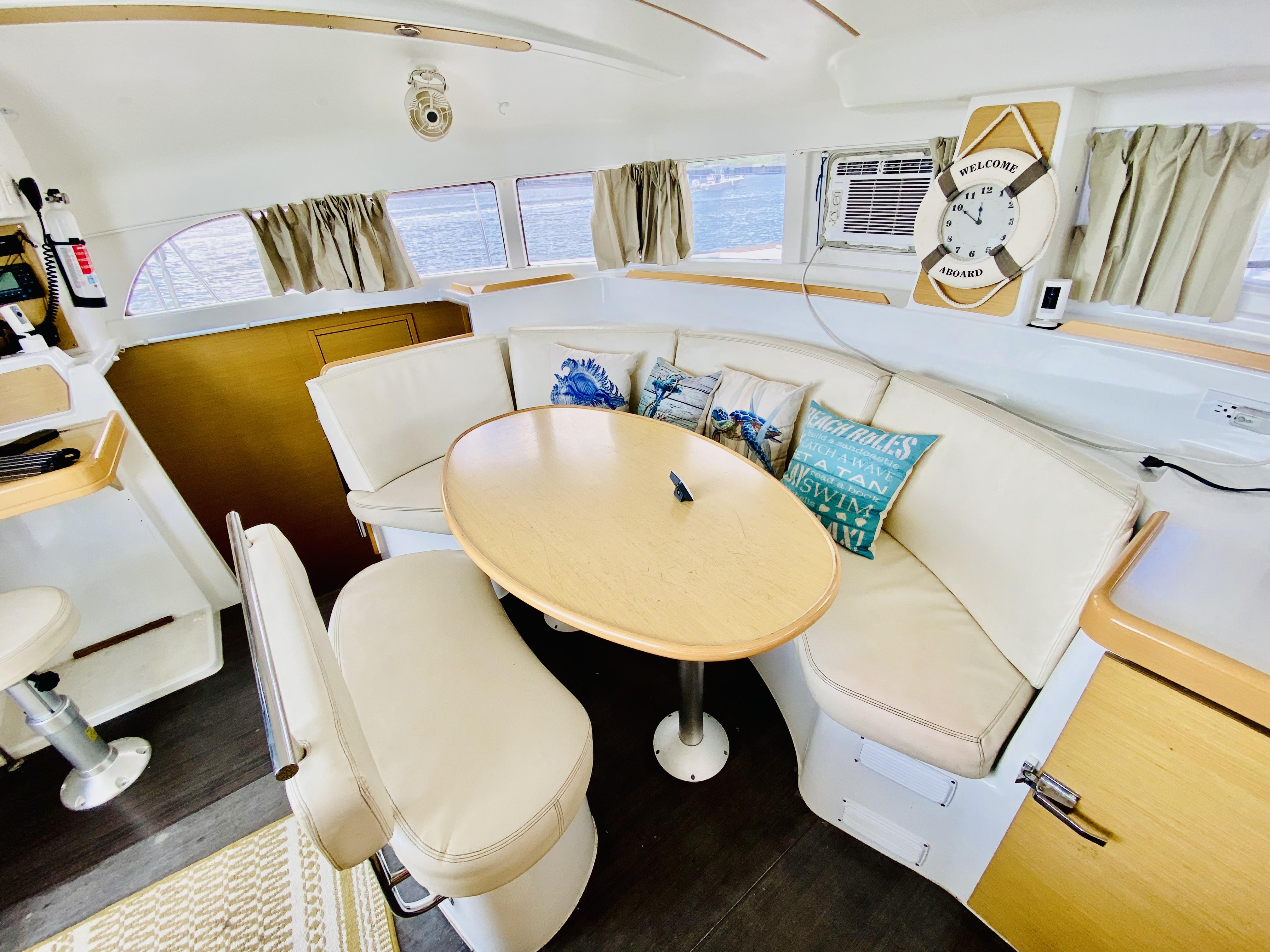 Interior of 2014 Lagoon 380 S2 catamaran with cozy seating and nautical decor.