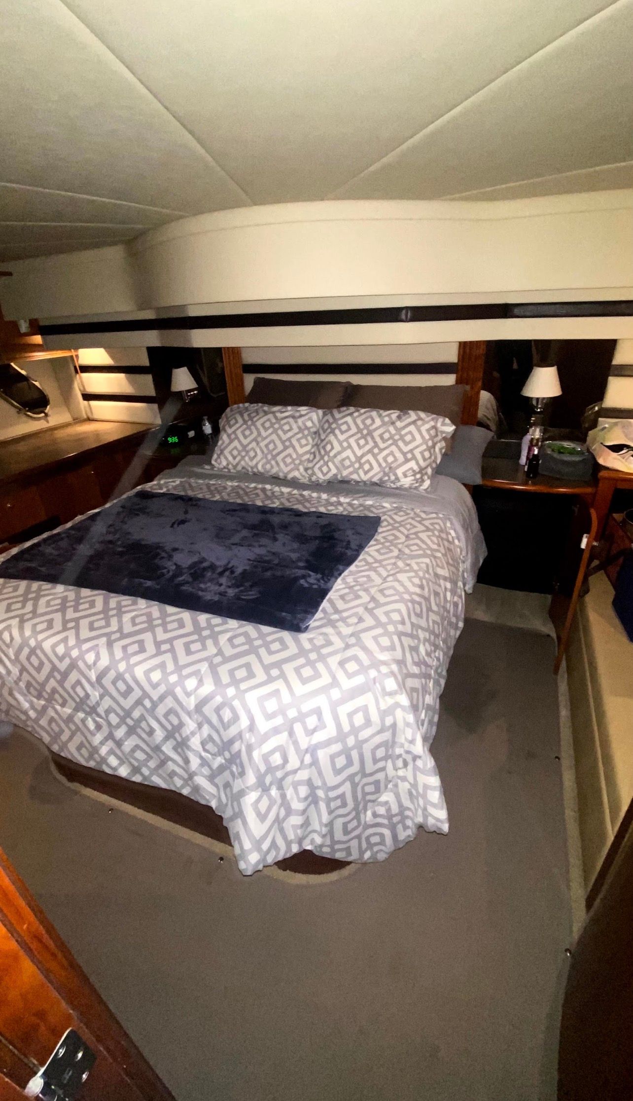 Interior of a 2009 Cruisers Yachts 520 Sports Coupe with a cozy bed and nightstands.