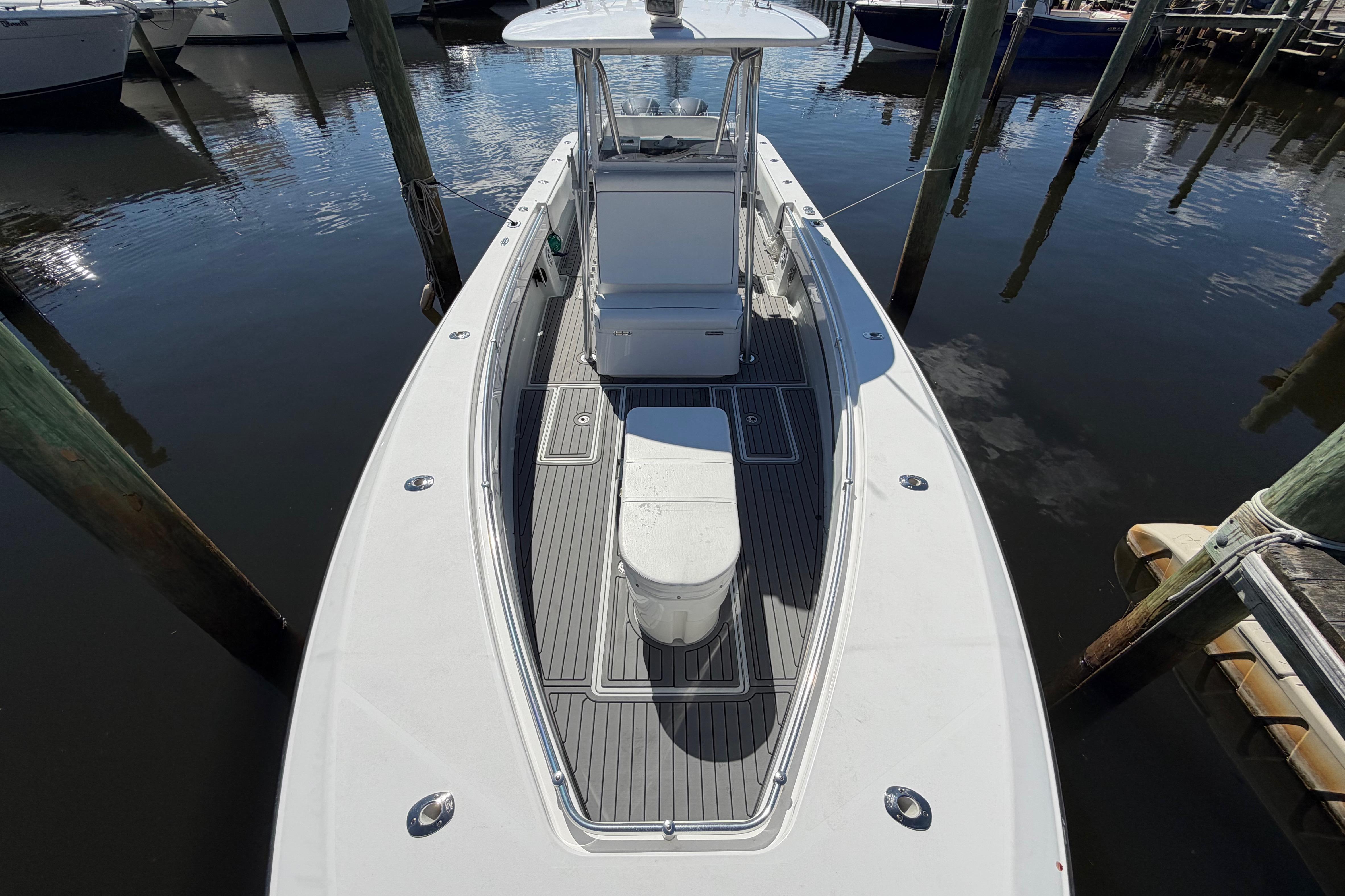 2015 Contender 32 ST boat docked, showcasing sleek design and spacious deck.