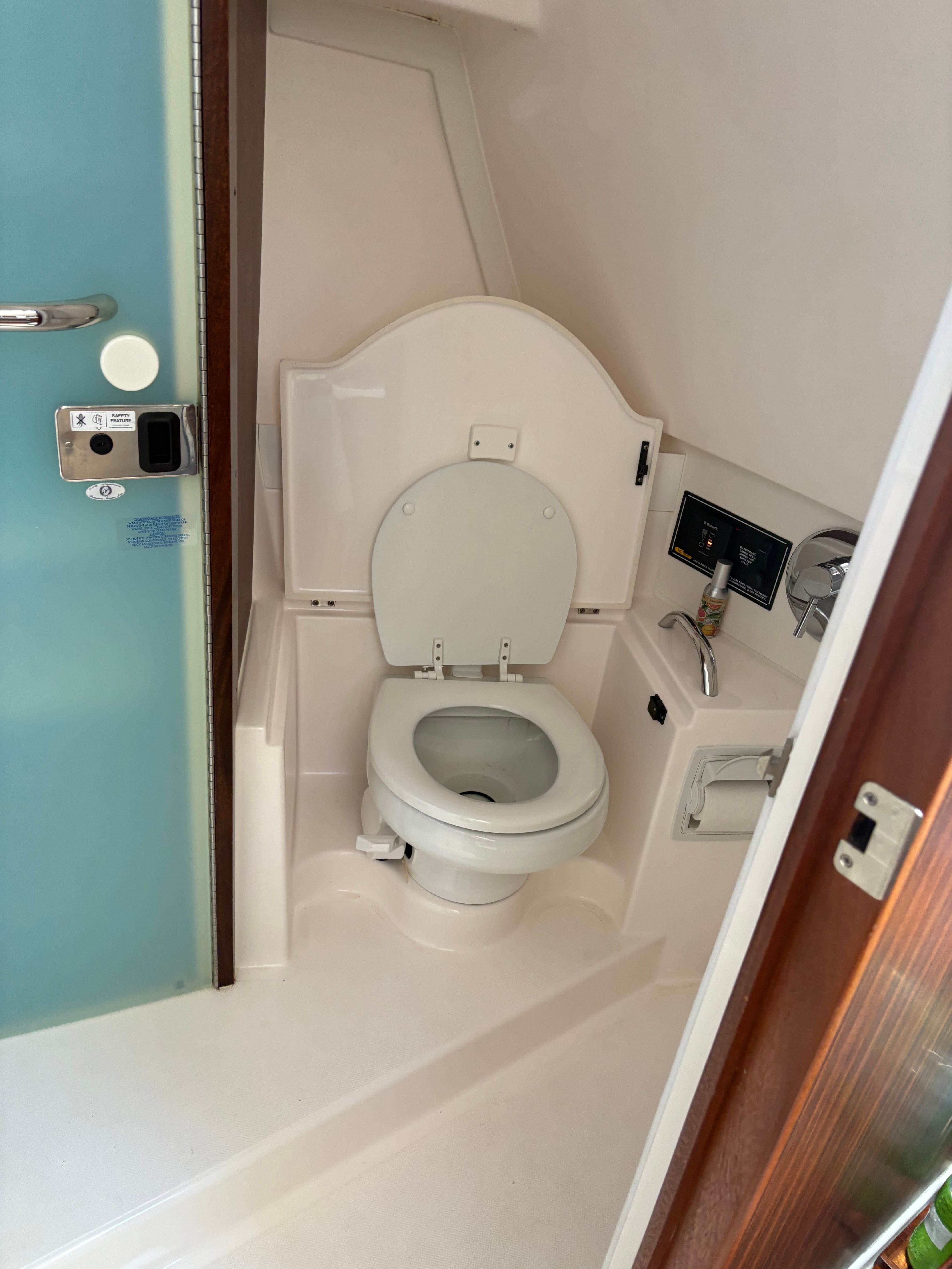 2017 Pursuit OS 355 Offshore boat bathroom with toilet and sink.