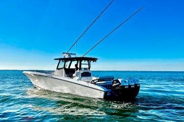 2023 Fountain 38 Tournament Edition boat on open water under clear blue sky.
