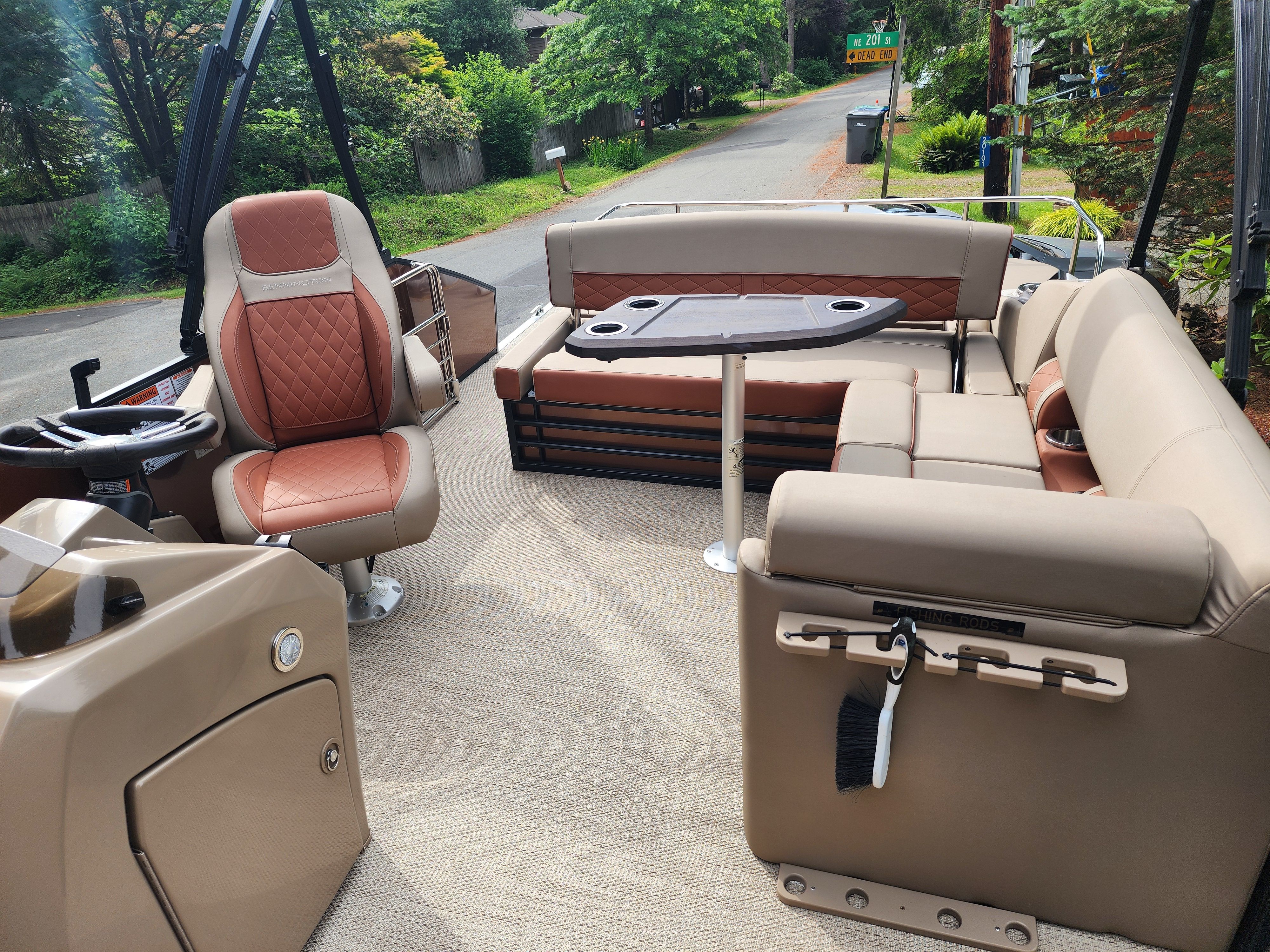 Interior view of a Bennington 22 LSB pontoon boat with beige and red seating.