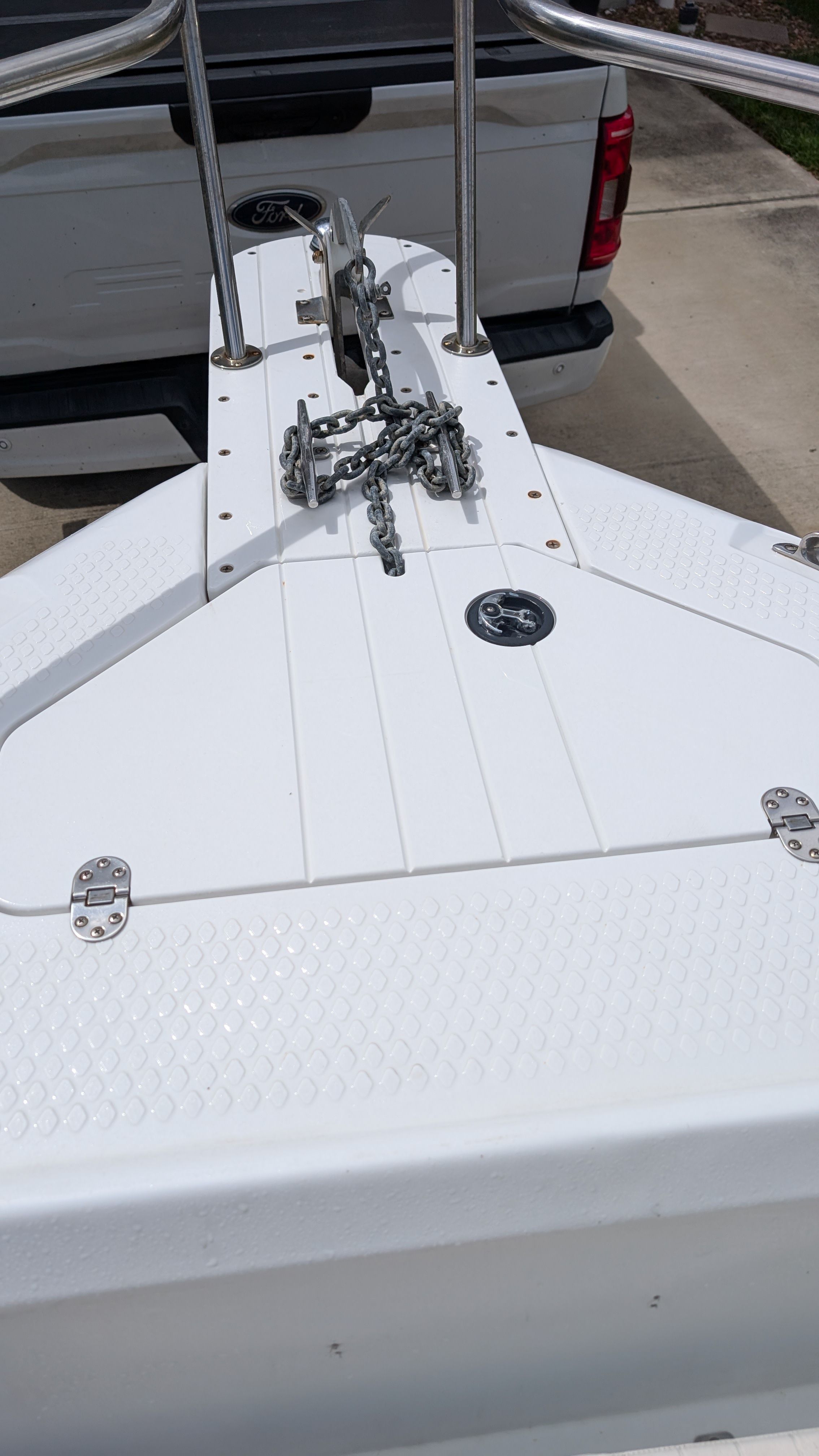 The image shows the bow deck of a 2007 Triumph 215 CC boat with anchor chain.