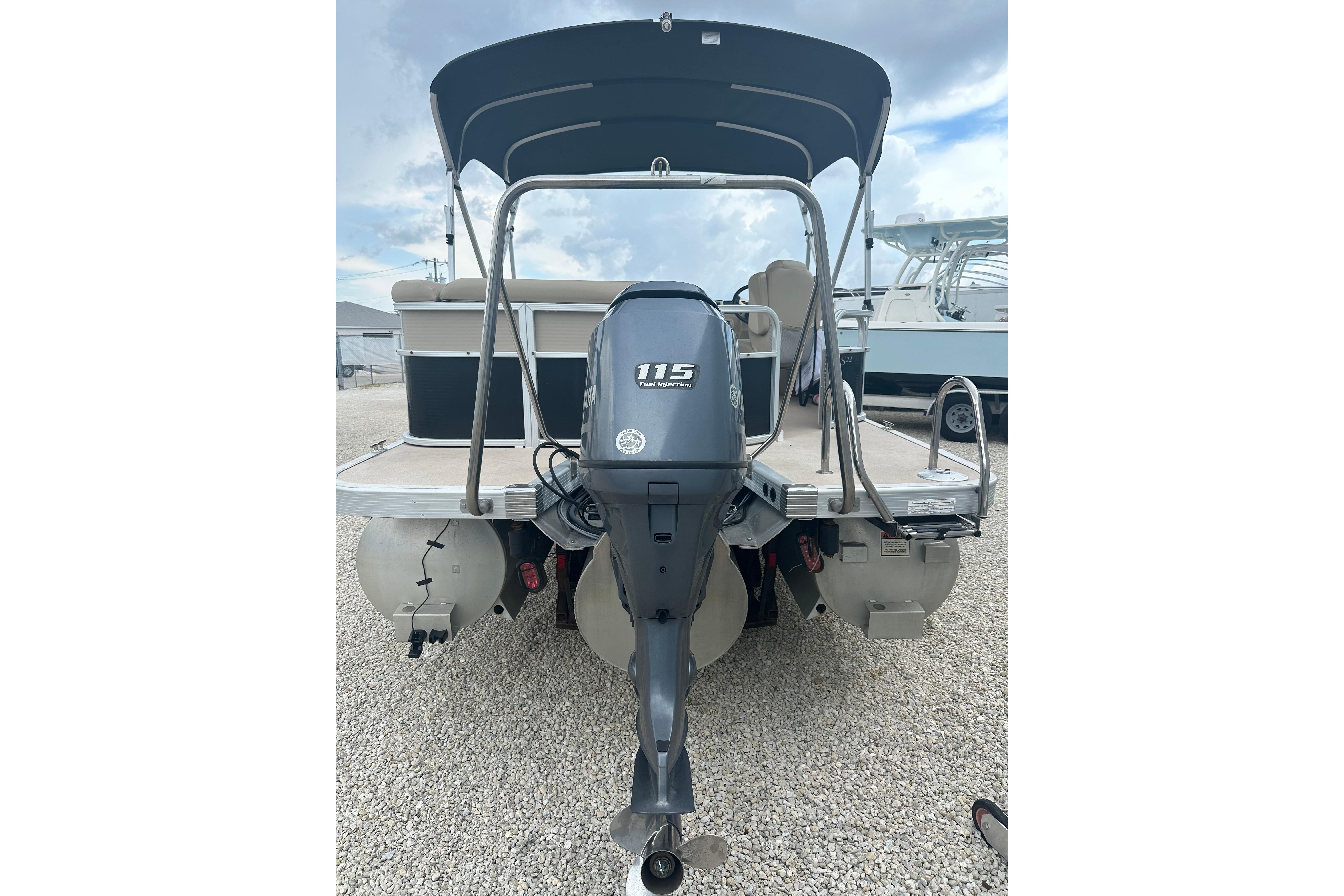 2014 Bennington S22 pontoon boat with 115 horsepower outboard motor, rear view.