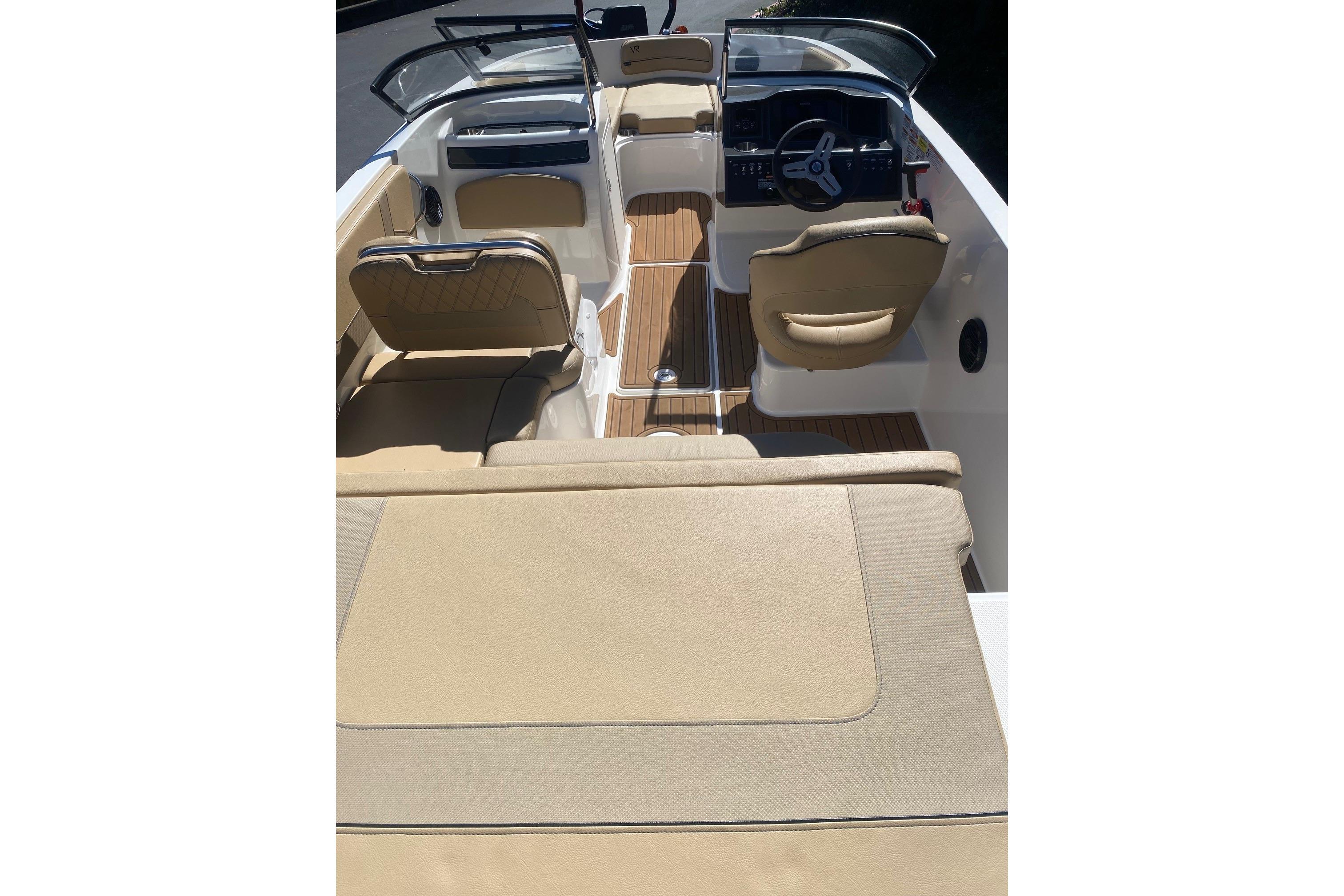 2023 Bayliner VR5 Bowrider I/O interior with beige seating and wood accents.